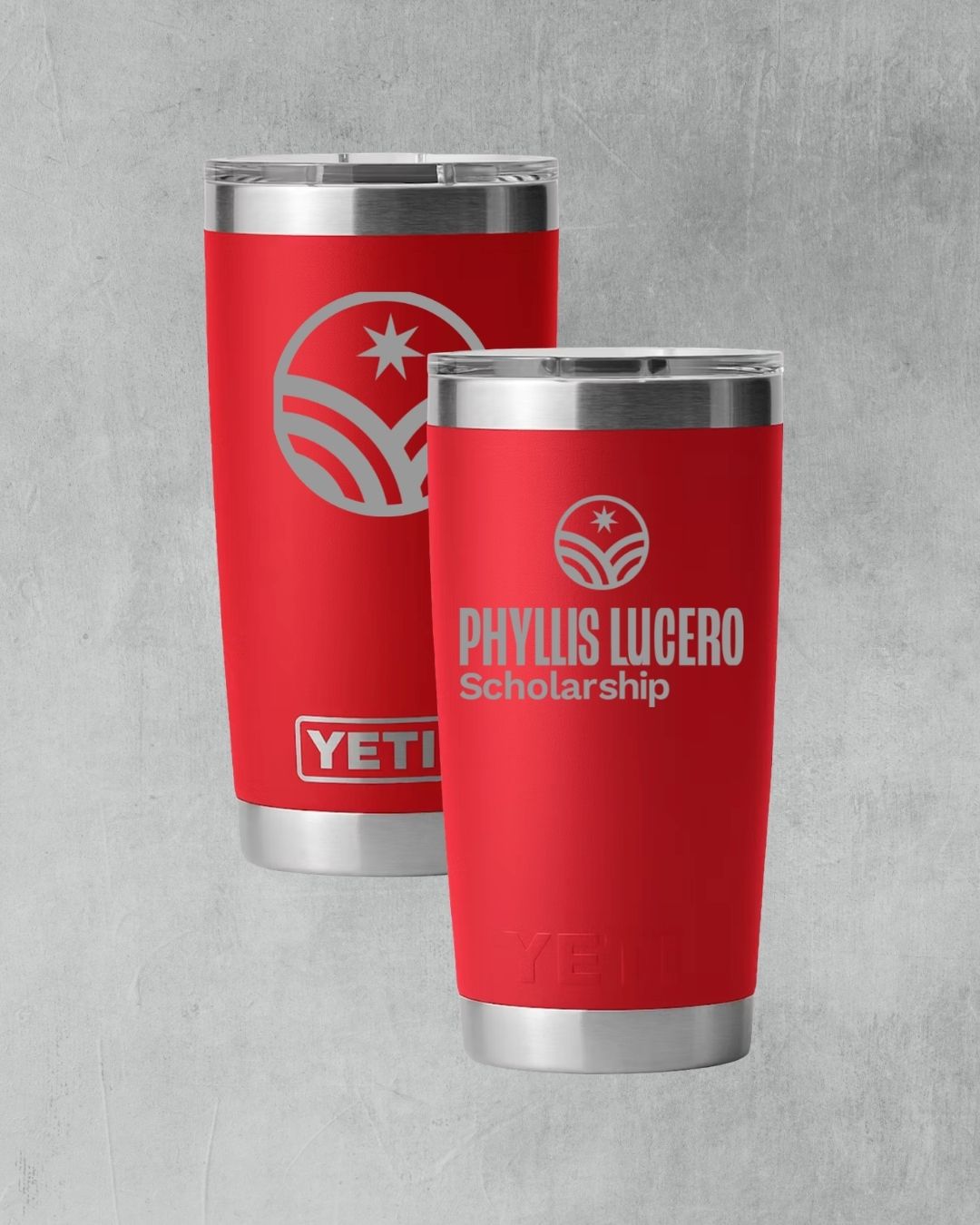Two red YETI tumblers engraved with the Phyllis Lucero Scholarship logo on a gray background.