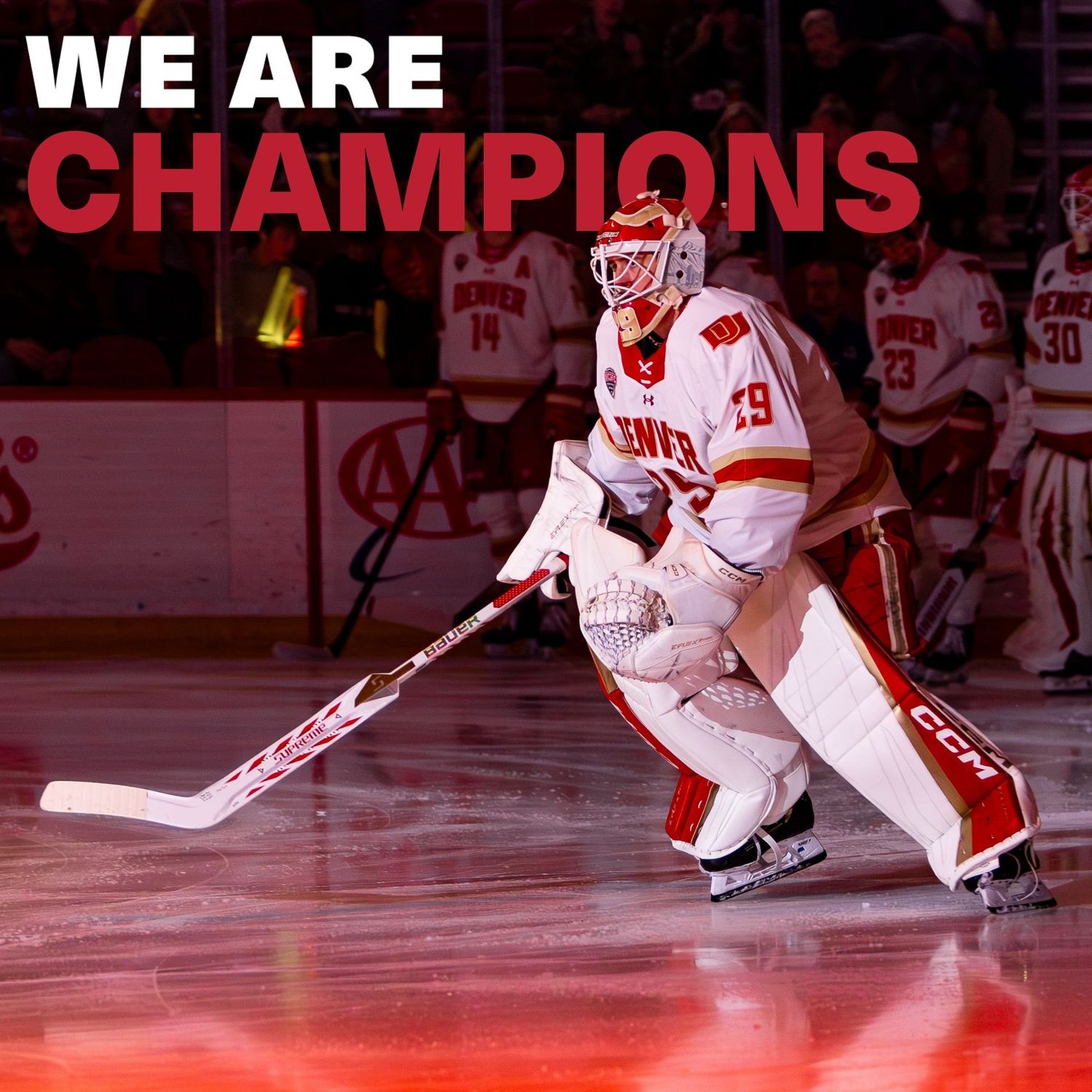 Denver hockey goalie in red and white uniform on ice rink with We Are Champions text overlay.