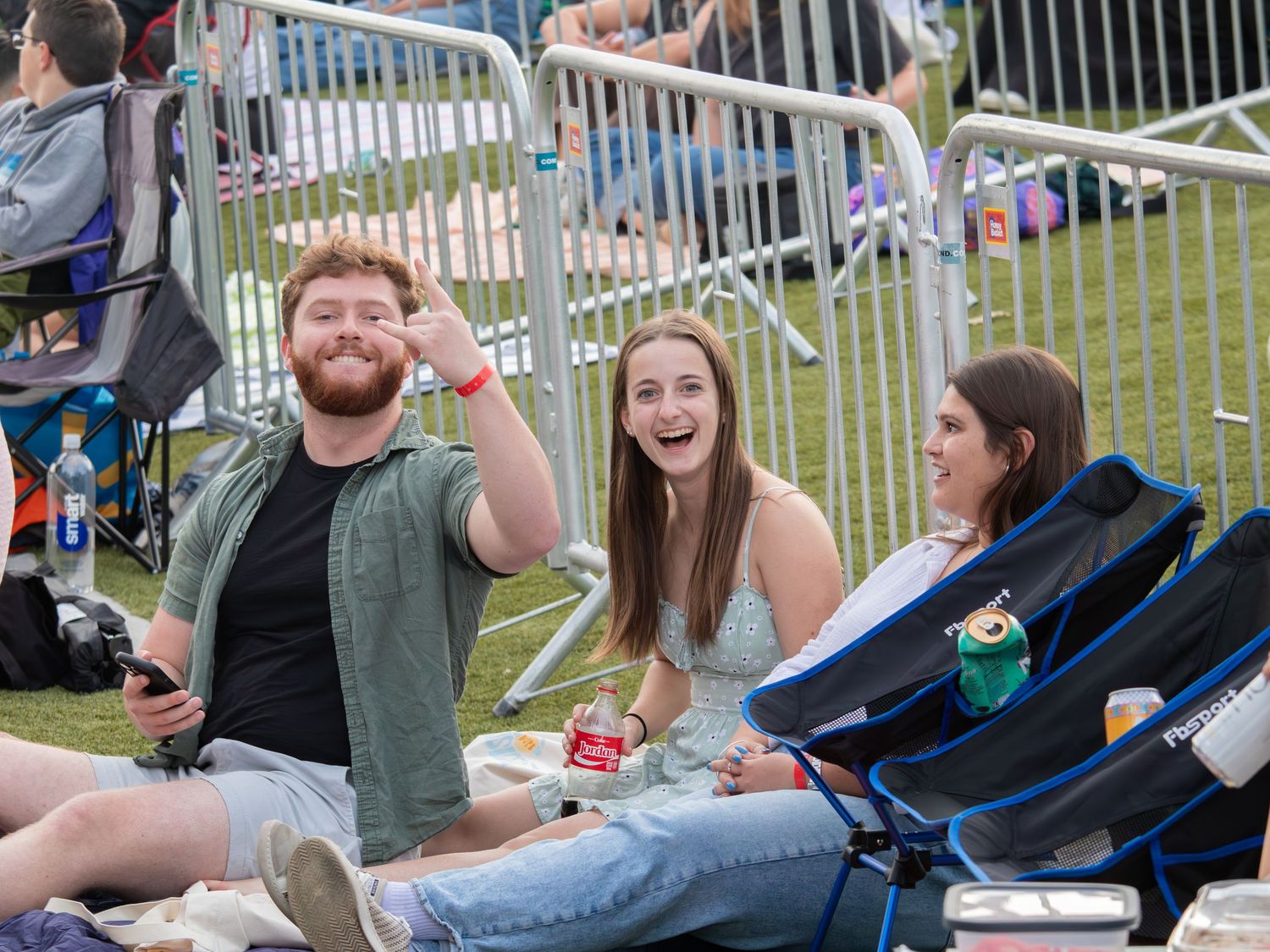 Students relaxing on grass during an outdoor campus event.