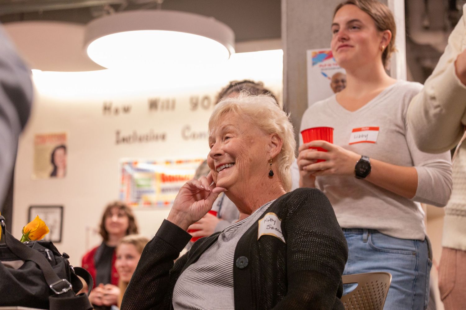 A group of people laughing and smiling together during what appears to be a workshop or meeting session.