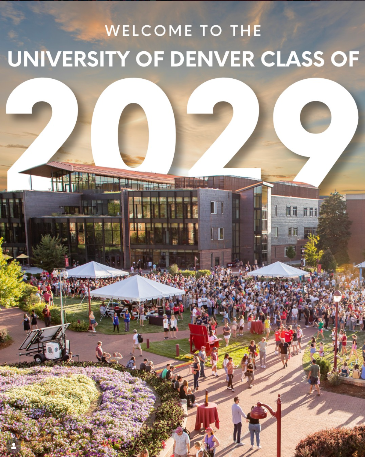 Welcome banner for University of Denver Class of 2029 showing campus buildings and outdoor event with large crowd gathering.