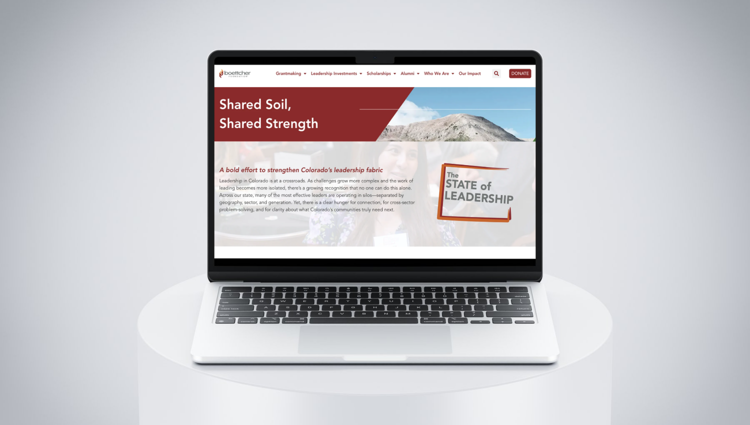 Laptop displaying a website titled Shared Soil, Shared Strength with a State of Leadership book graphic.