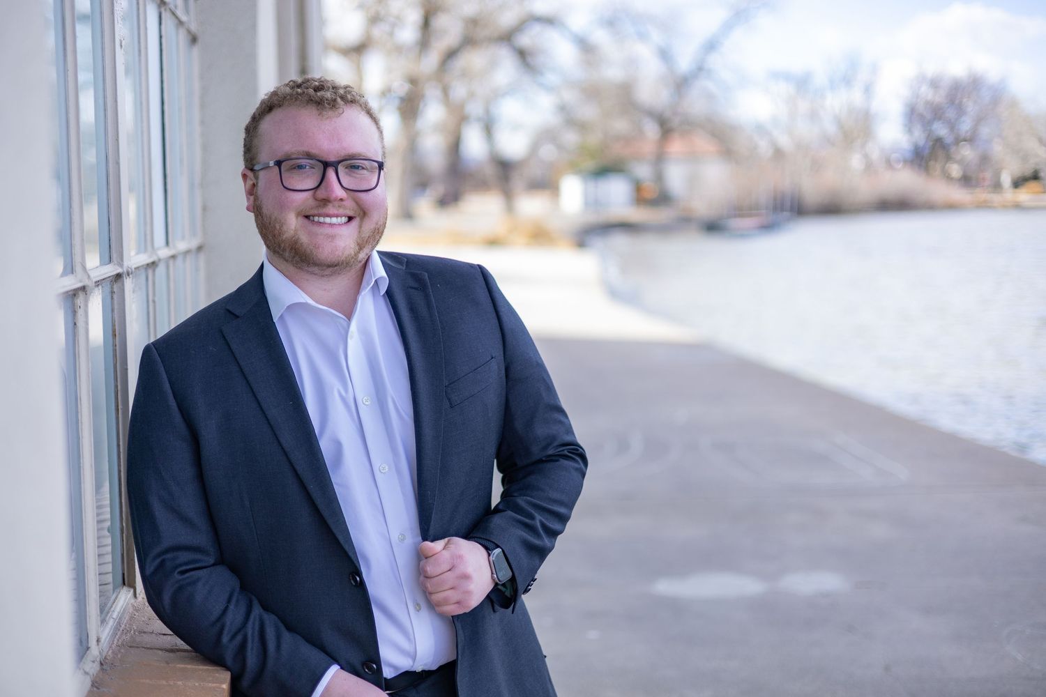 Professional headshot portraits of a person in business attire with glasses against outdoor backgrounds.