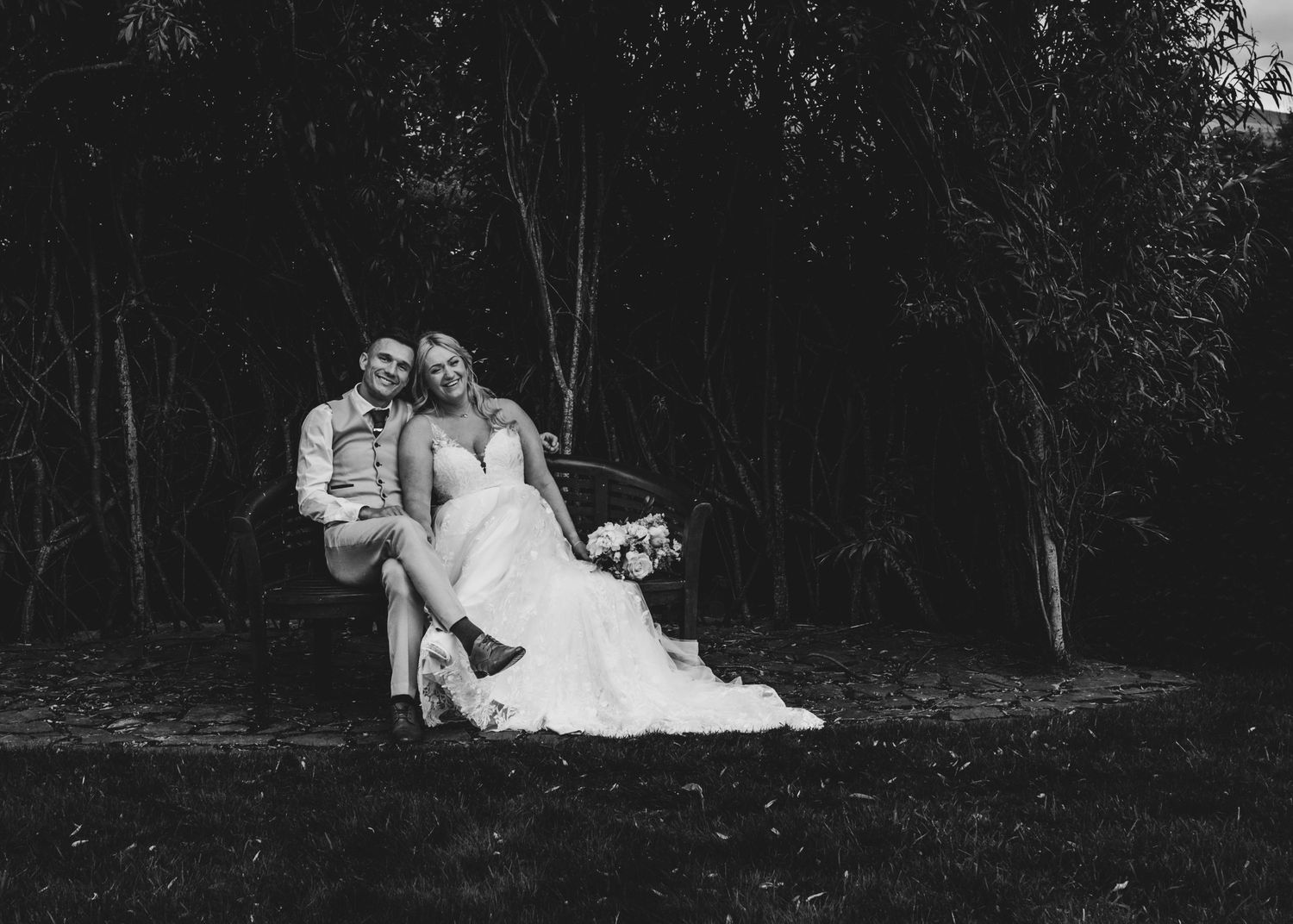 Artistic black and white wedding photography in a natural wooded setting.
