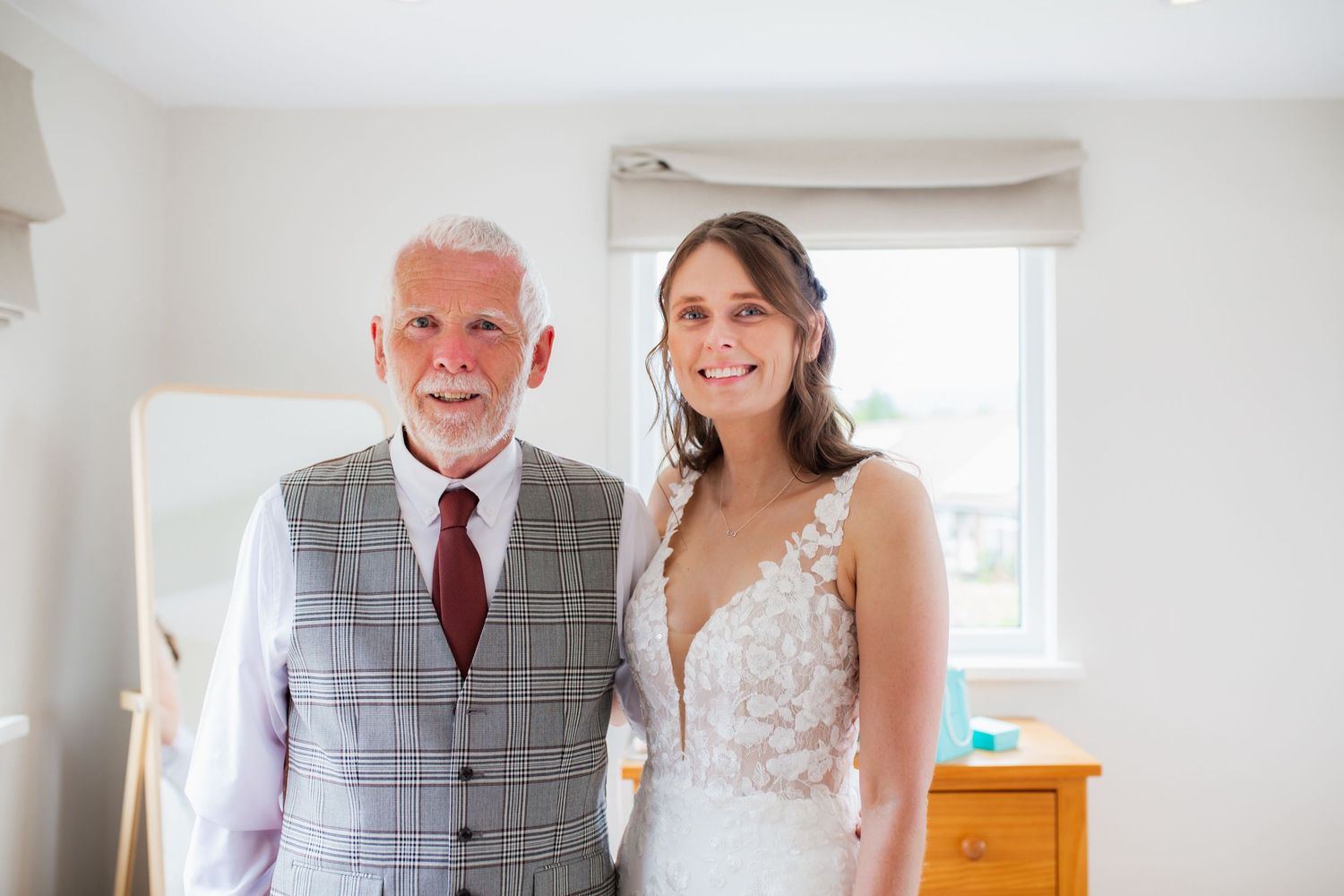 A heartwarming moment captured between a bride and her father in formal attire.
