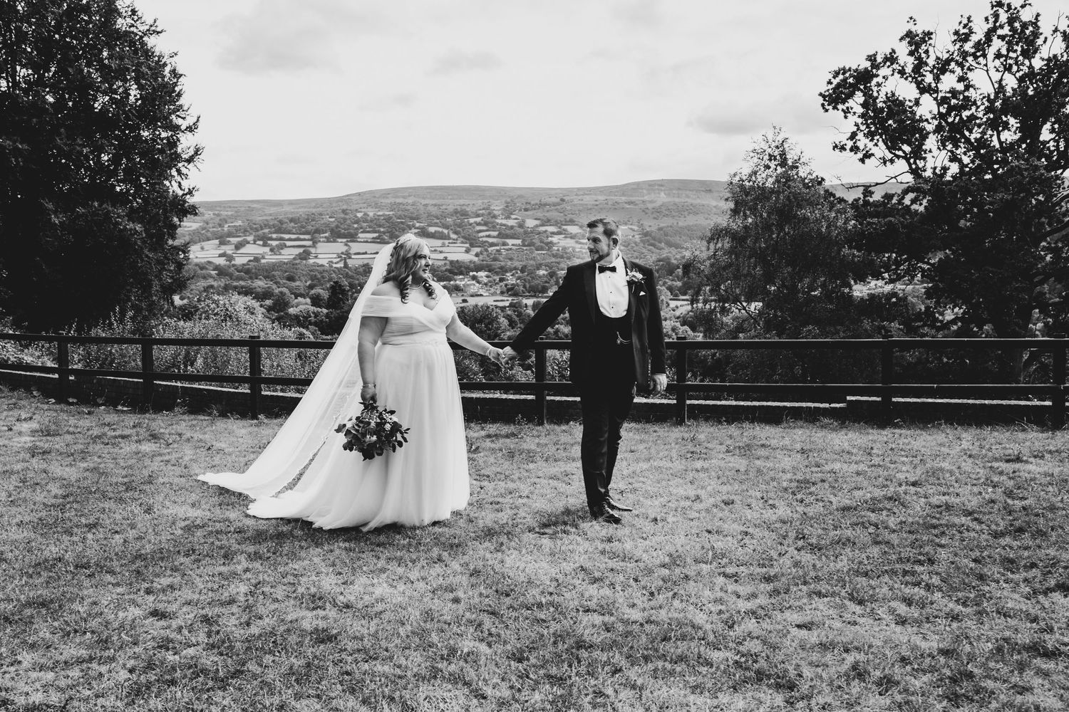 Romantic black and white wedding photos showing elegant couple celebrating in scenic countryside setting with mountains.