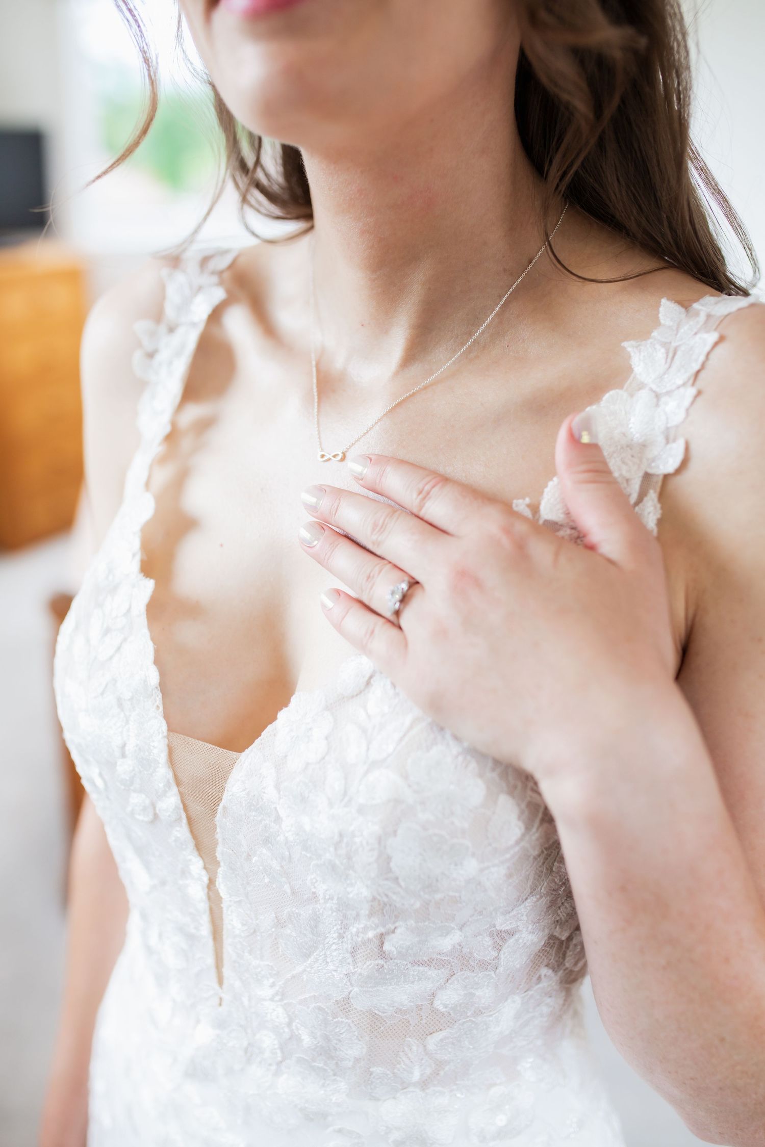 Detail shot of a lace wedding dress bodice with delicate floral appliques.
