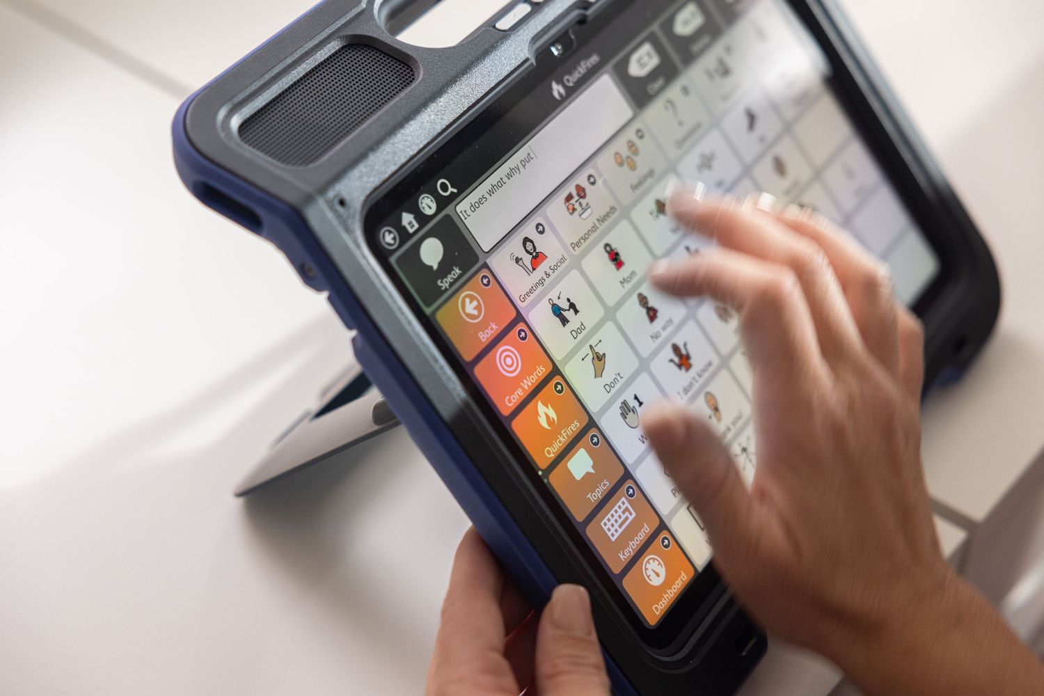 Hand pressing buttons on a point-of-sale payment terminal with colorful interface.