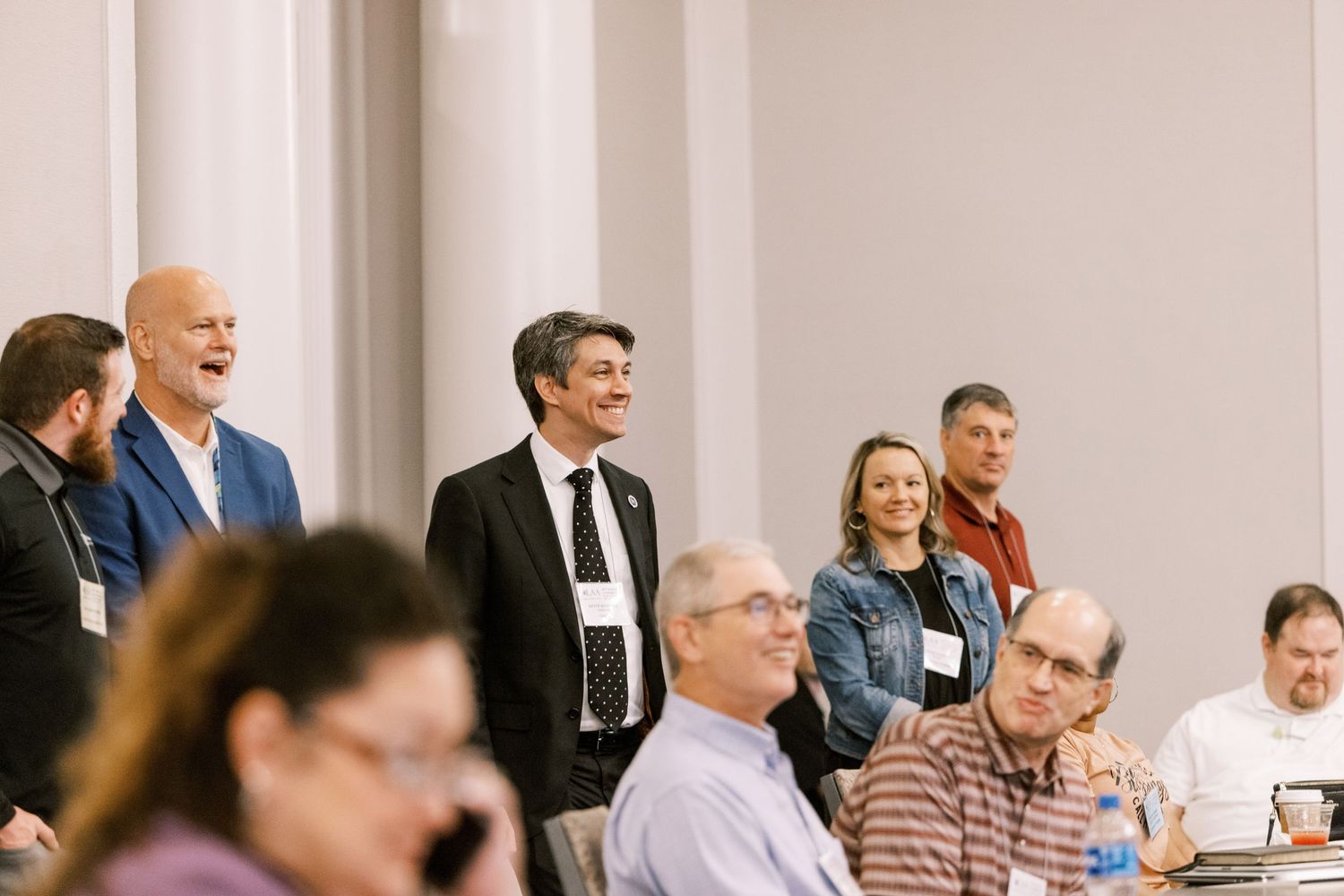 Attendees gather in a conference room during a professional meeting or presentation.
