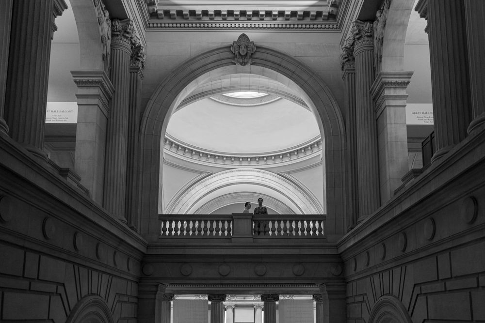 Grand neoclassical architectural details showcase ornate moldings and arches in a historic building's interior.