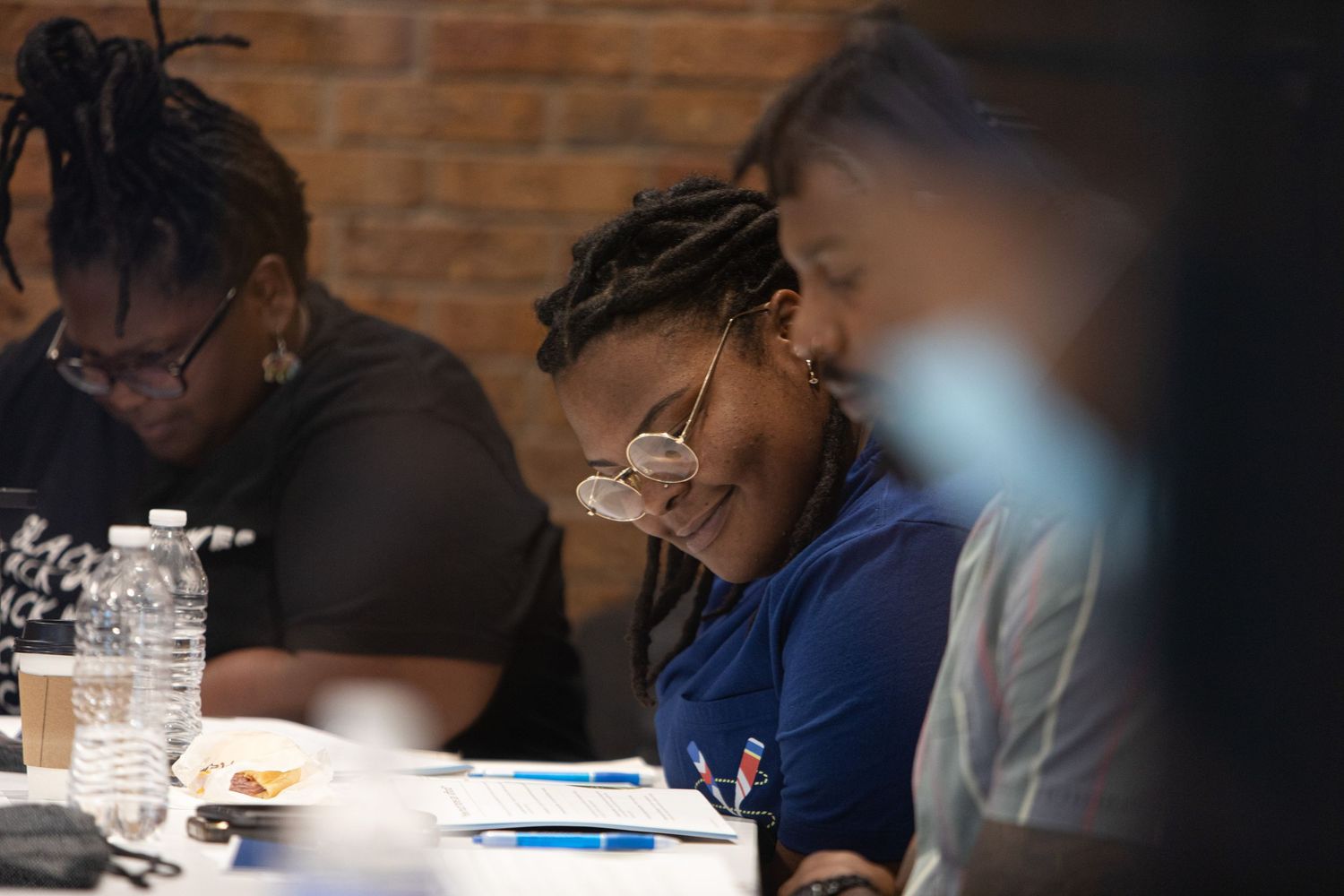 Participants sharing a light moment during a workshop session with documents on the table.