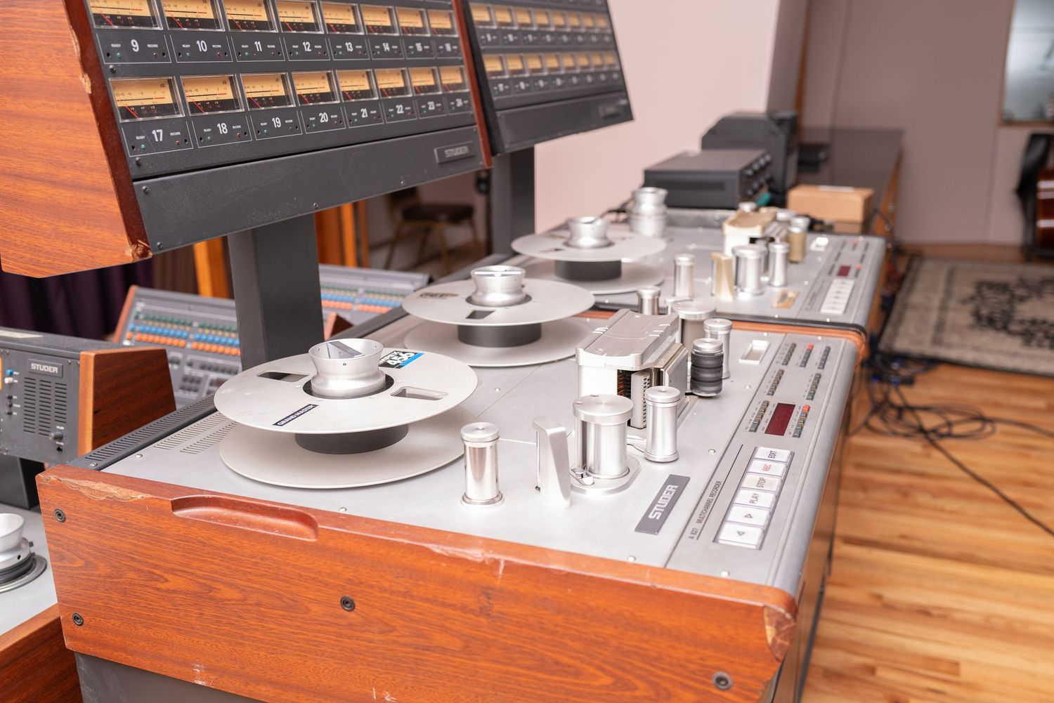 Vintage audio mixing console with wooden panels and multiple control knobs.