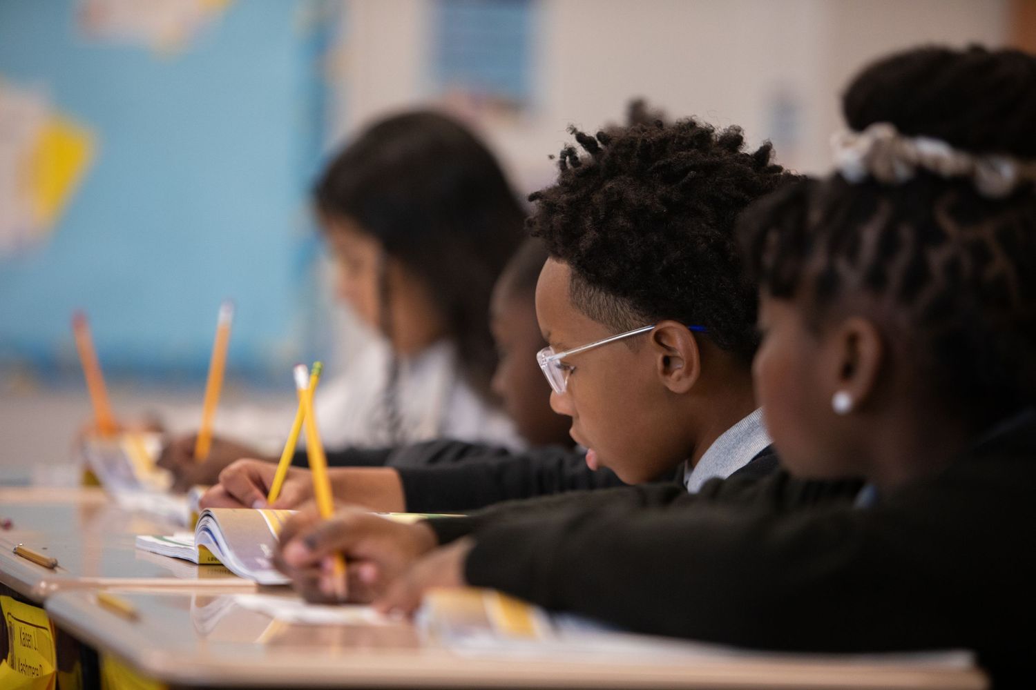 Students focused on their studies in a classroom environment.