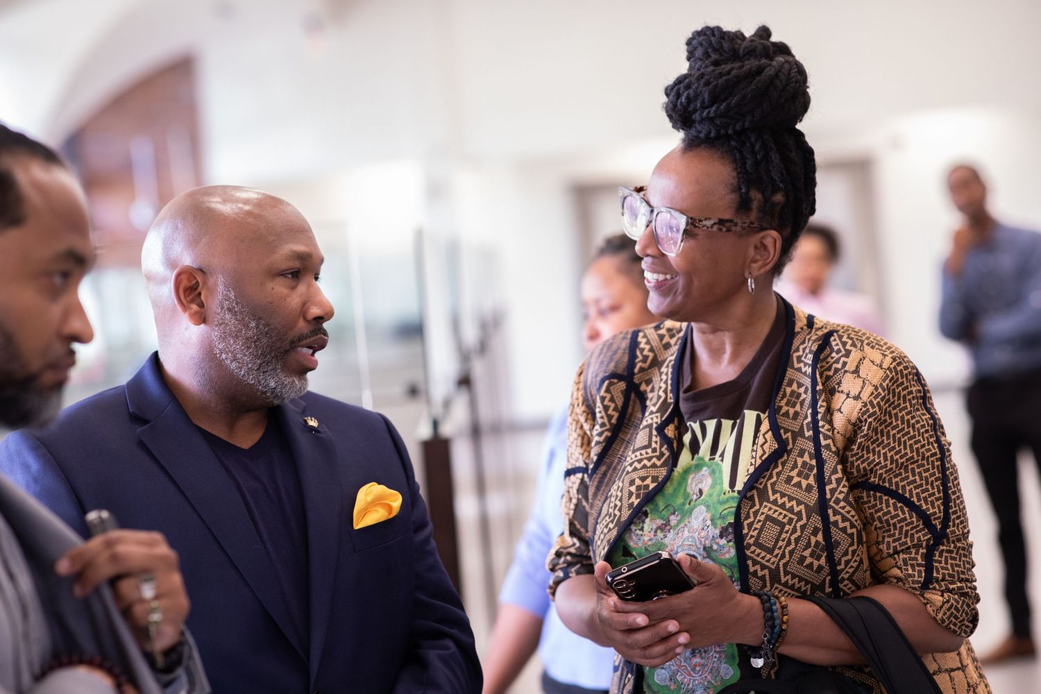 Professional networking conversation during conference or business event.