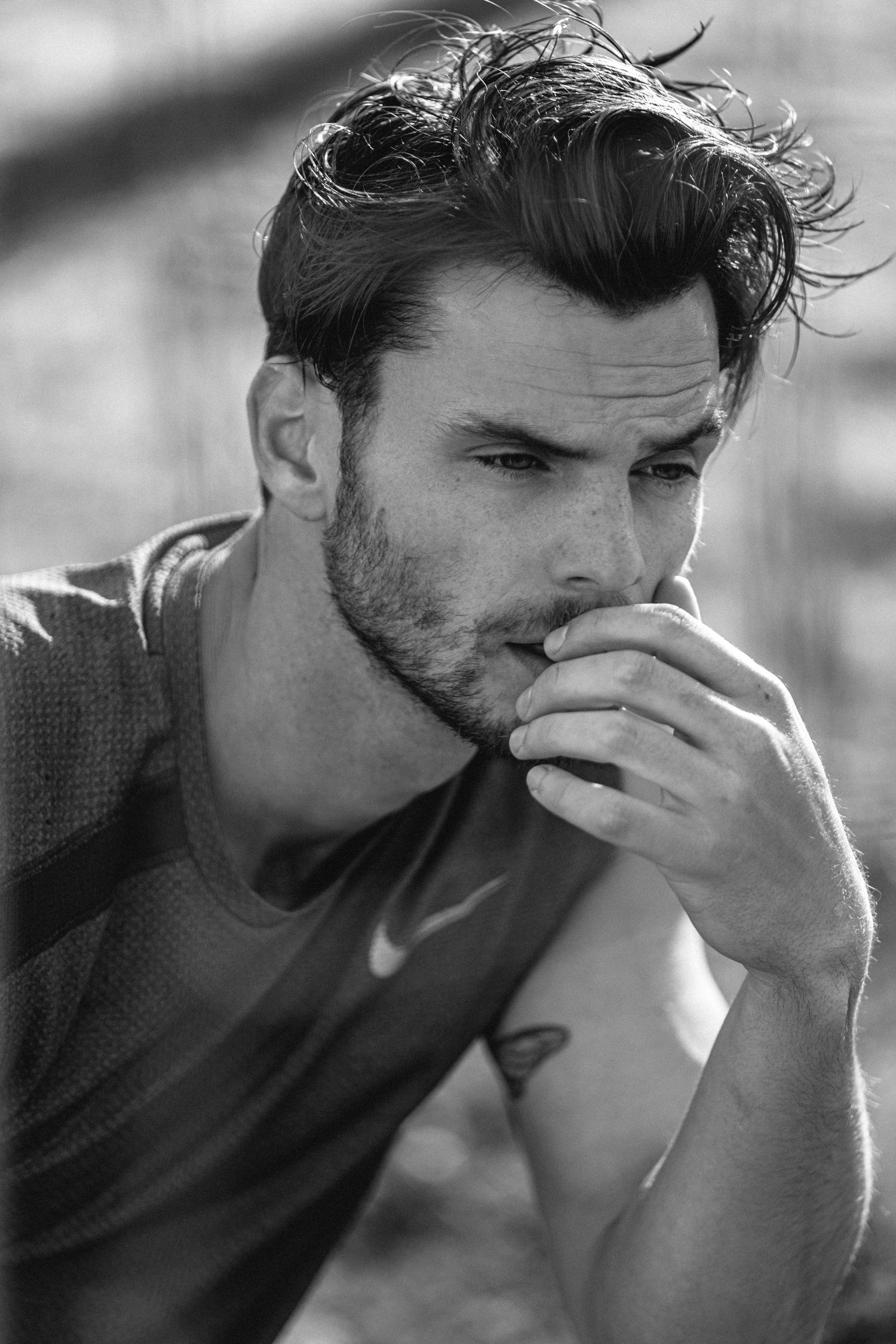 Black and white portrait series showing a man in deep contemplation with dramatic lighting and shadows.