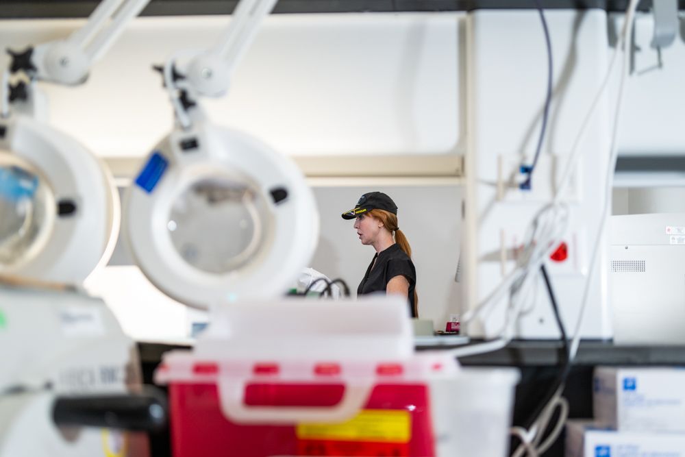 Medical laboratory with specialized equipment and workstations for scientific testing.