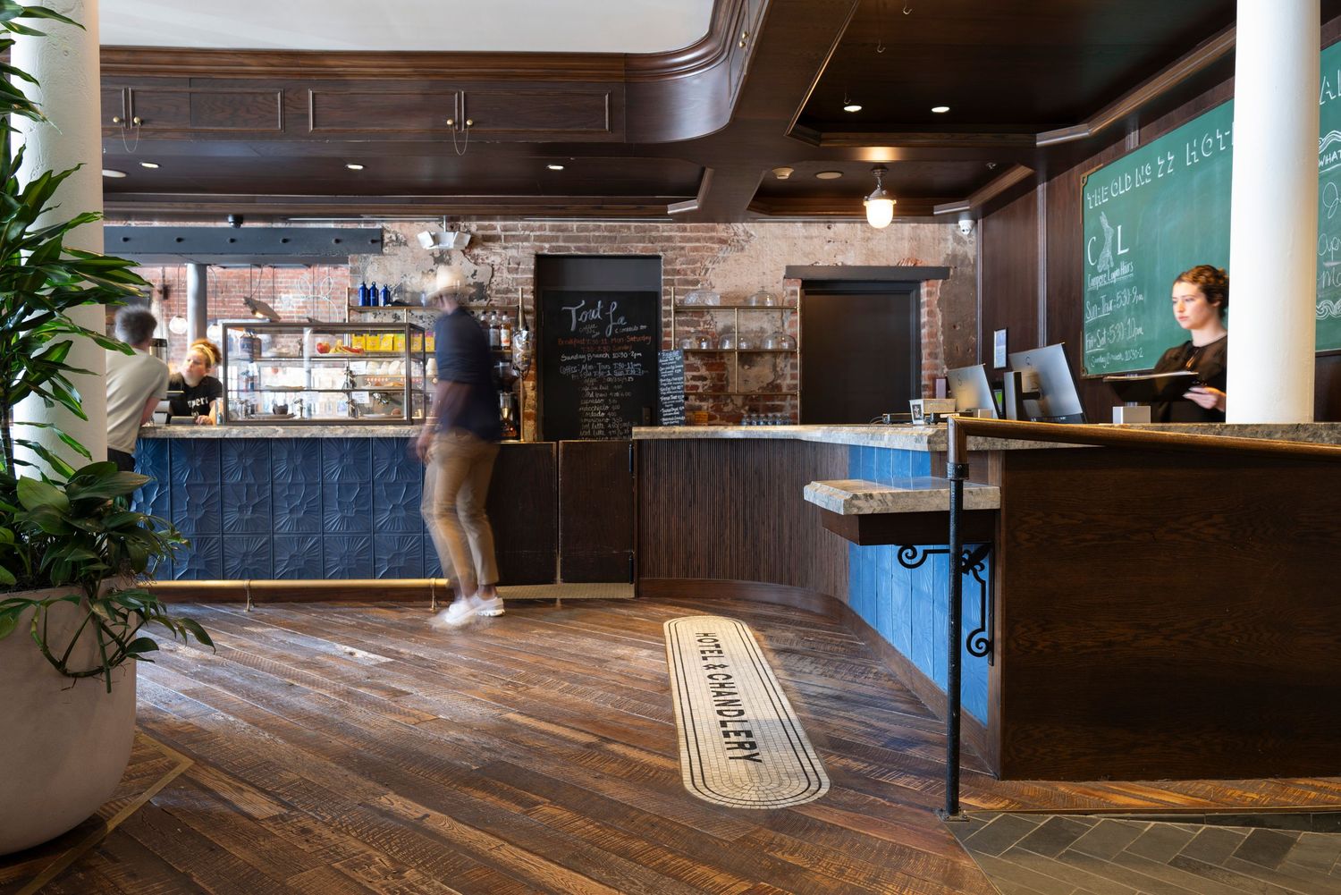 Modern cafe interior with wooden floors and counter service area.