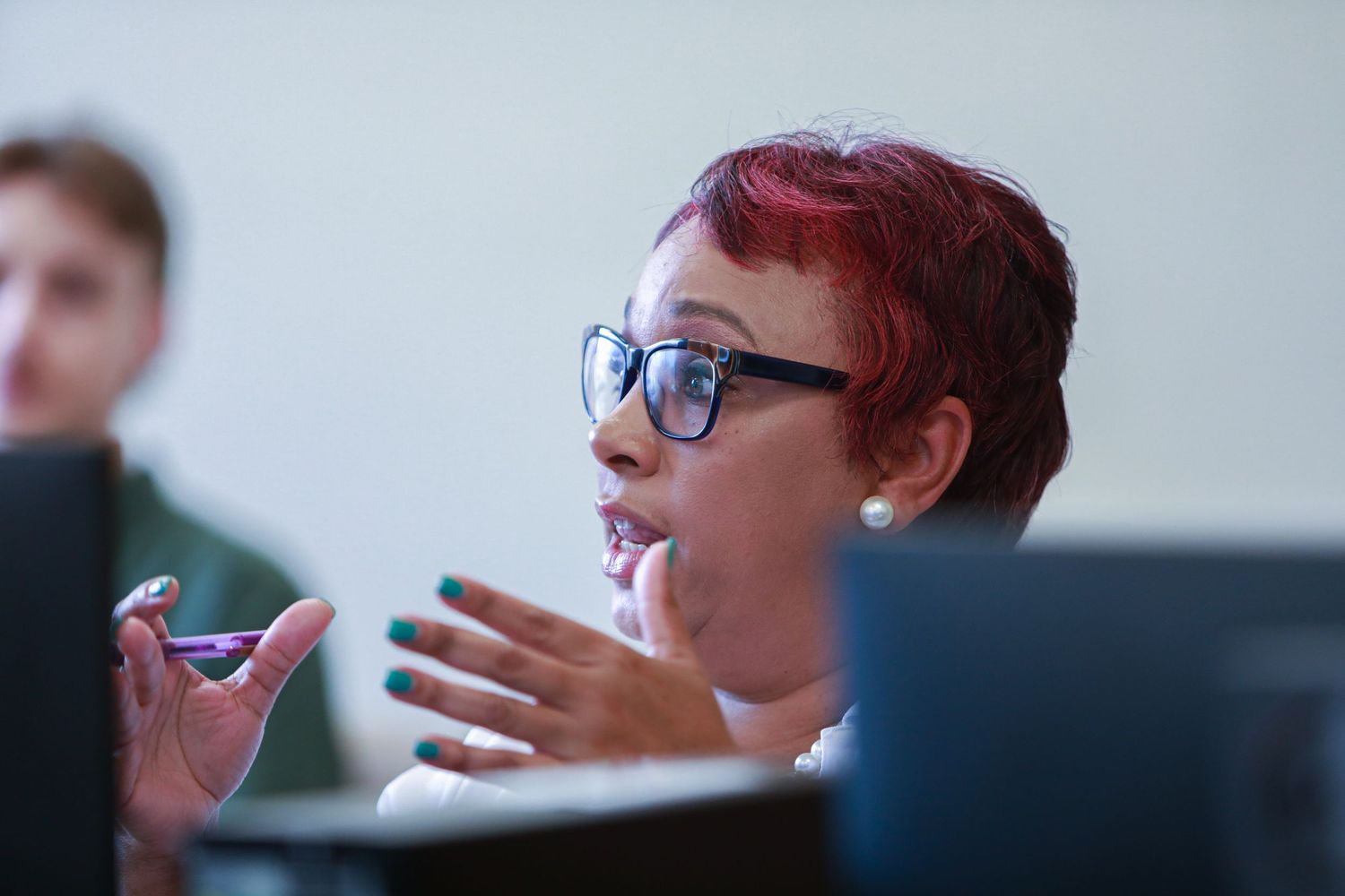 Participant gestures during a engaging discussion in a meeting room setting.