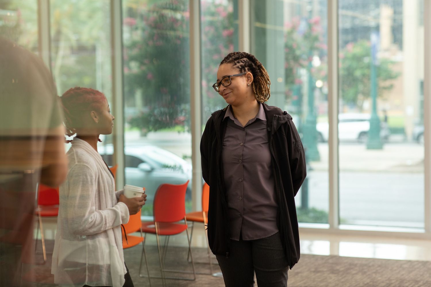 Professionals engaging in an animated discussion in a bright modern office setting.