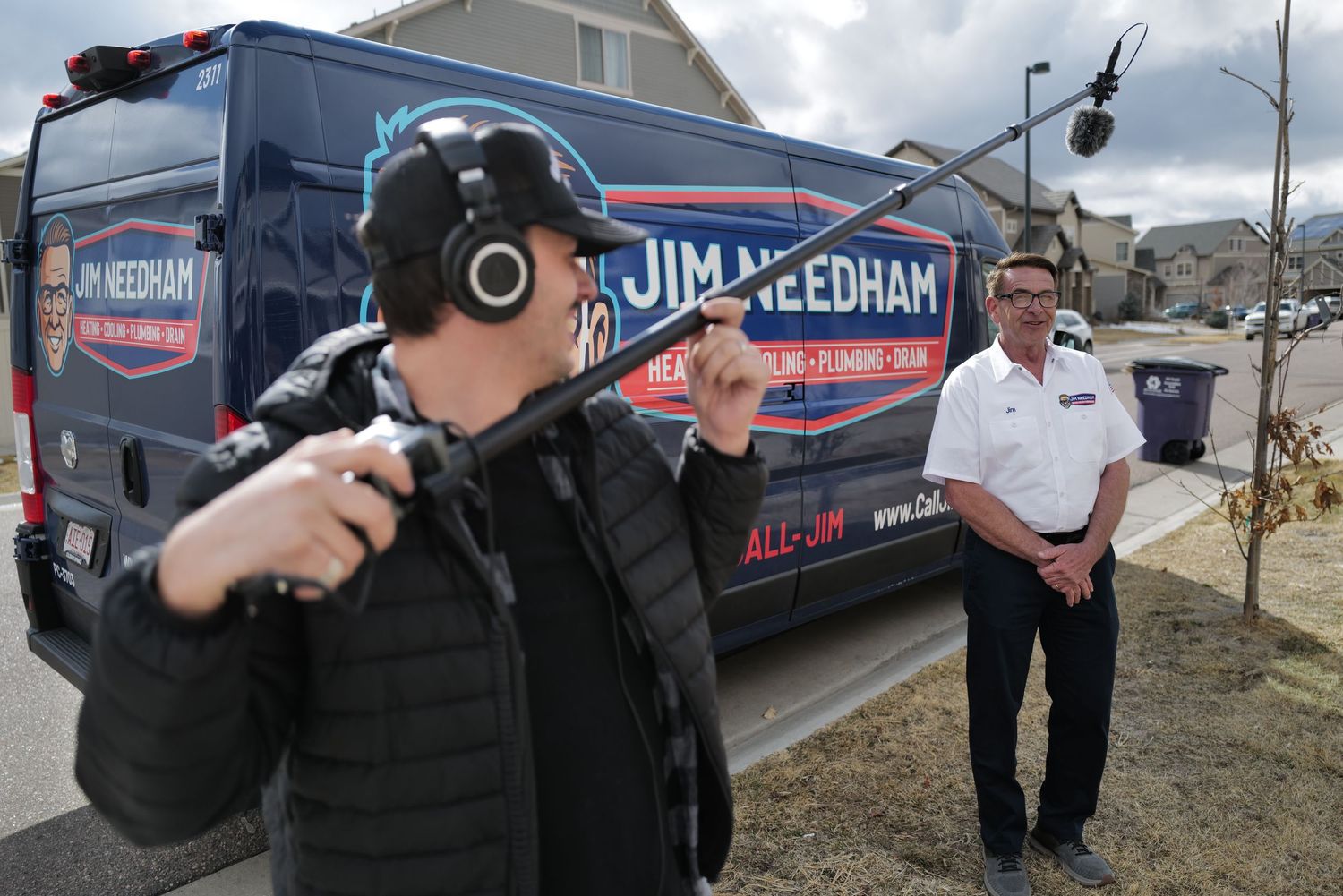 Jim Needham HVAC plumbing van with technician and boom mic operator during outdoor video shoot.