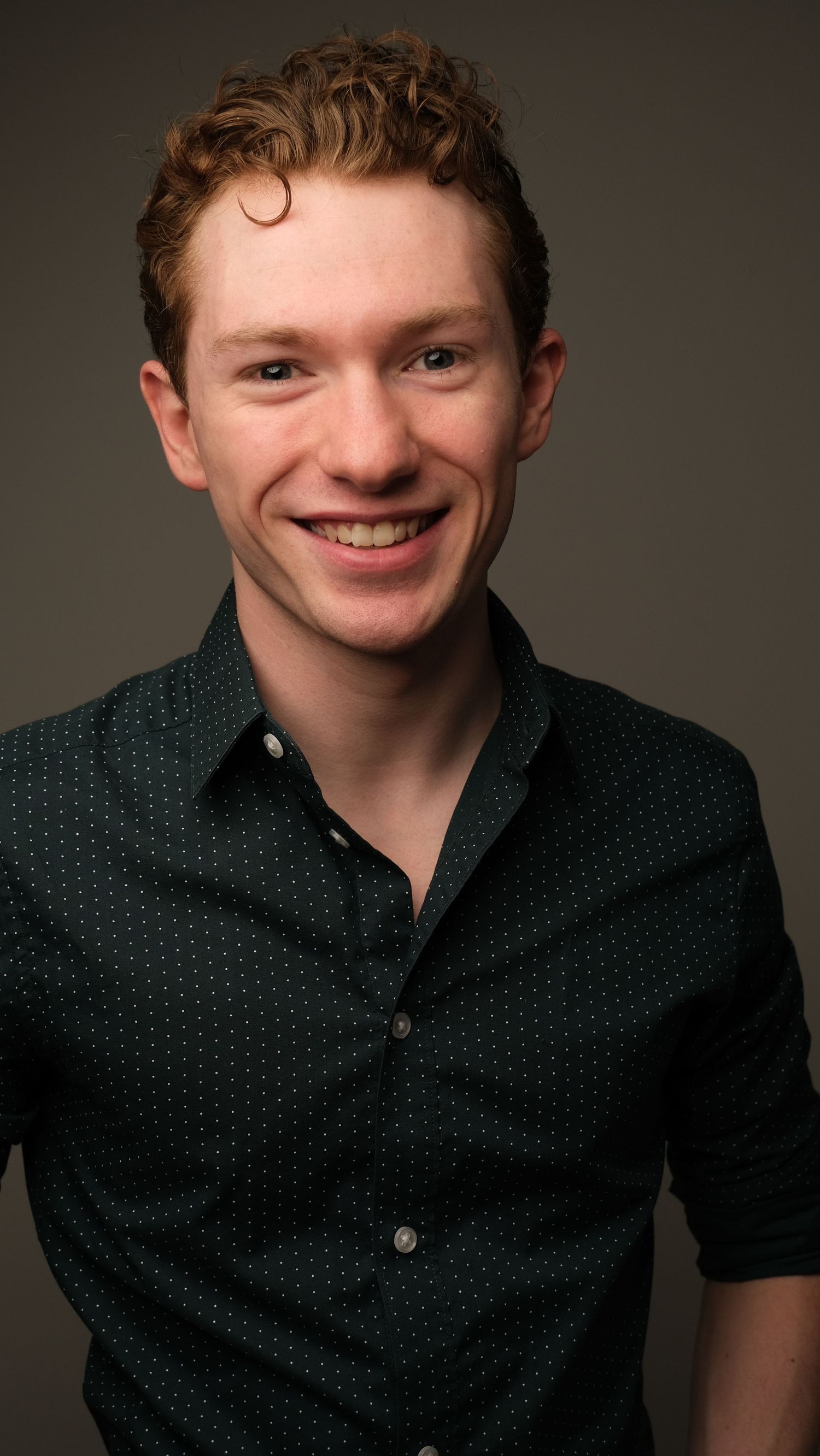 Portrait series showing subject in black polka dot shirt against neutral backdrop.