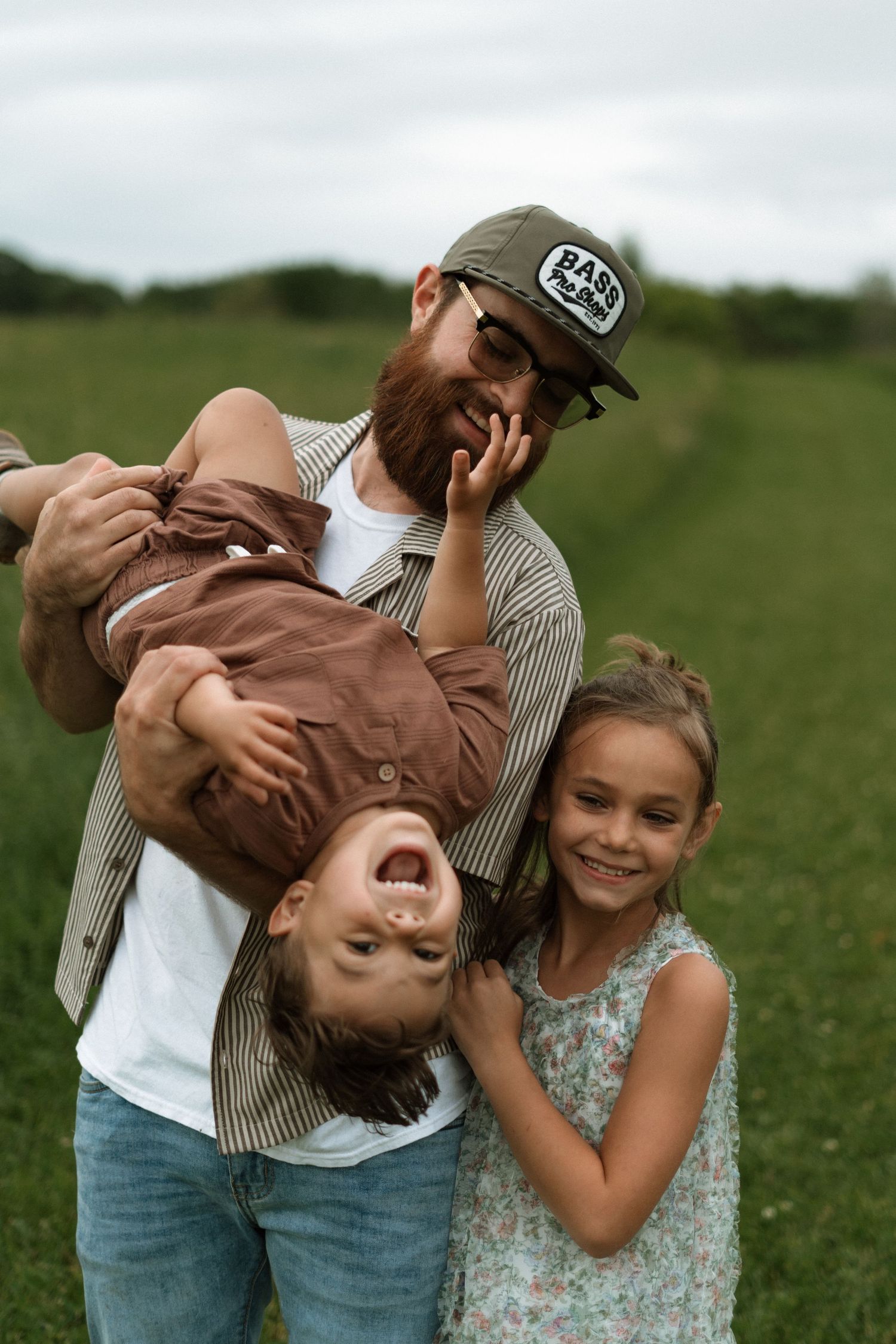 Multiple photos of a playful scene in a grassy meadow show joyful moments of togetherness and laughter.