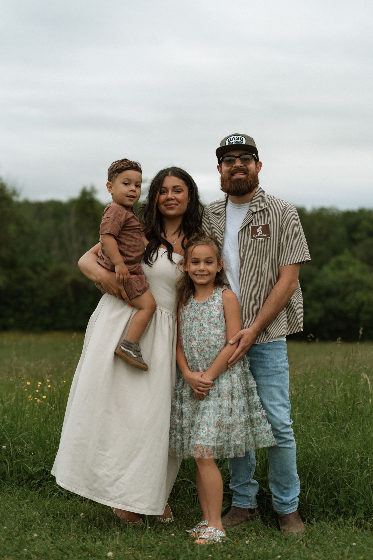 A candid family photoshoot in a wildflower meadow with natural lighting and rustic styling.