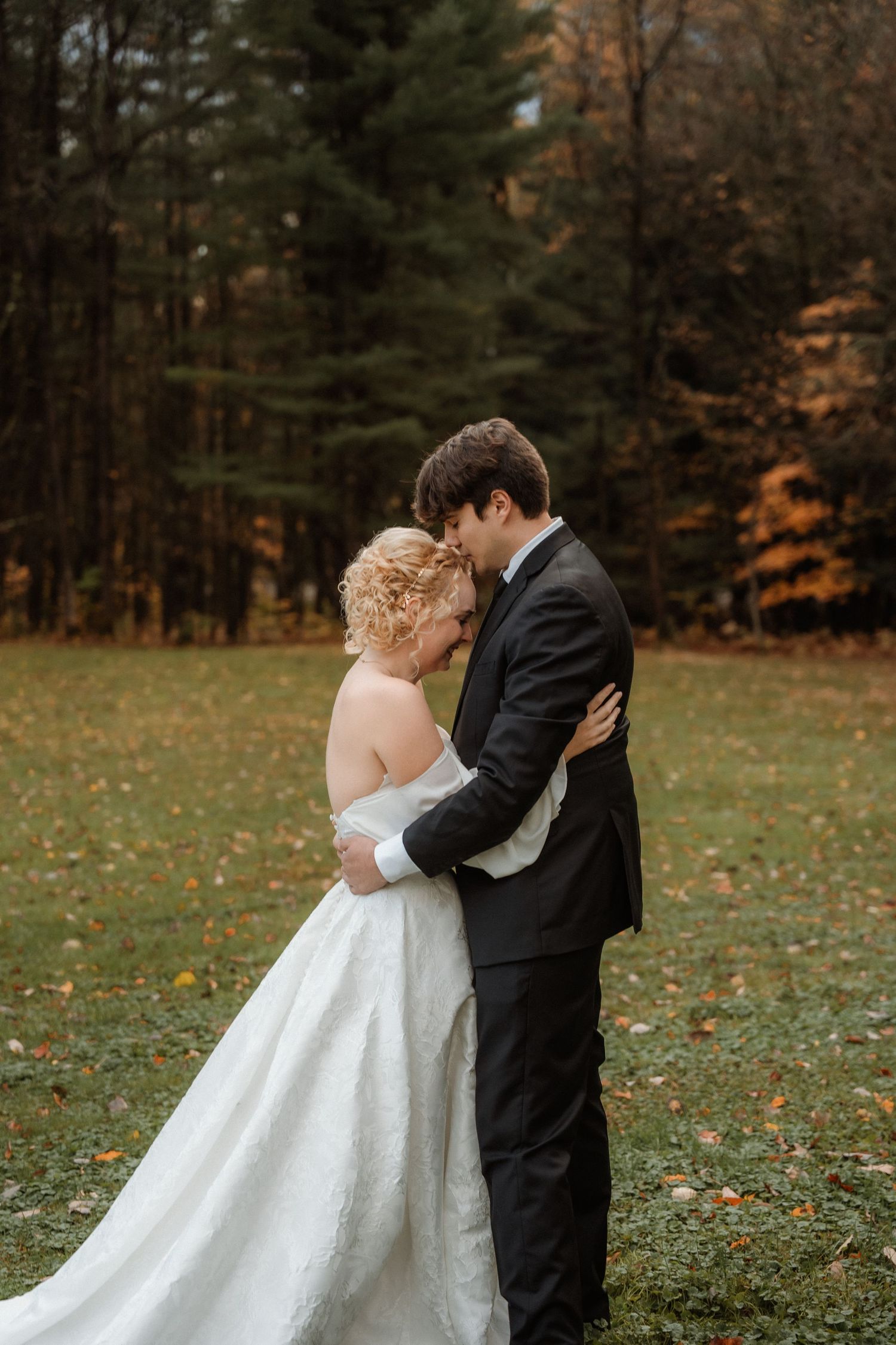 A romantic autumn wedding photo sequence shows a couple embracing in a wooded setting with fallen leaves on the ground.