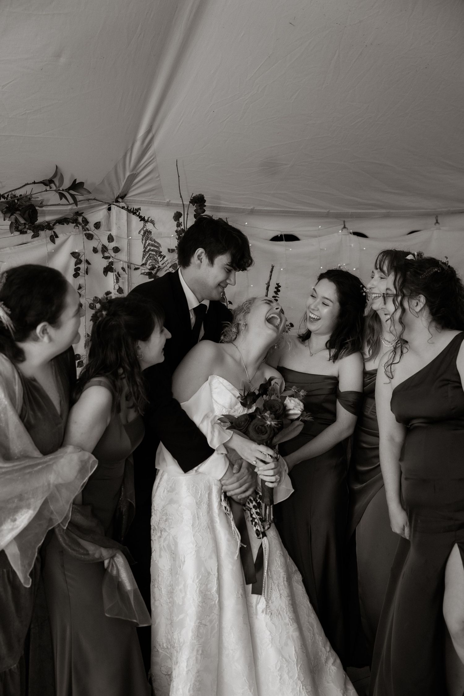 A sequence of black and white photos showing a group dancing and celebrating at a wedding reception.