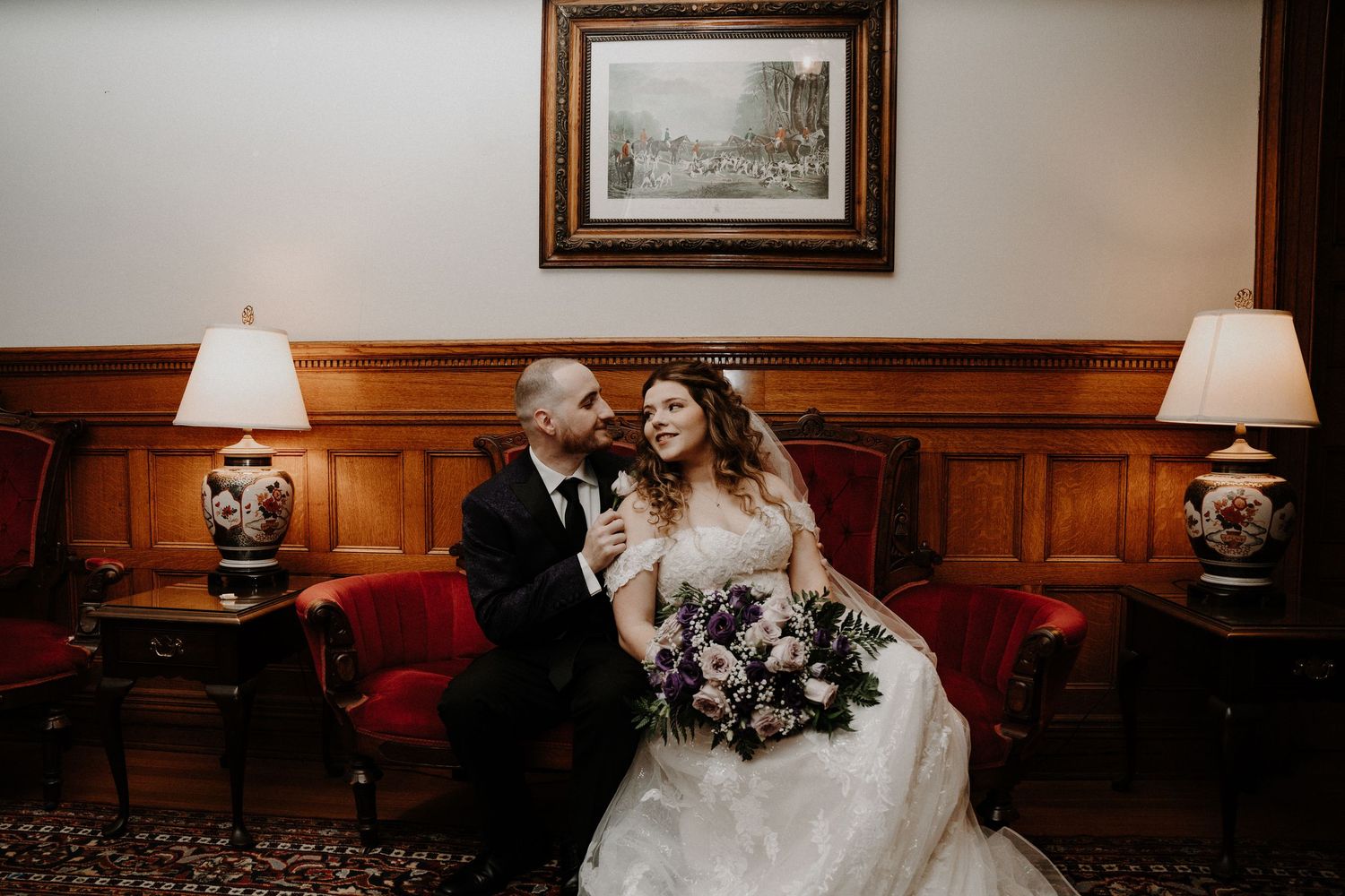 Wedding portrait in an elegant room with wood paneling and vintage decor.