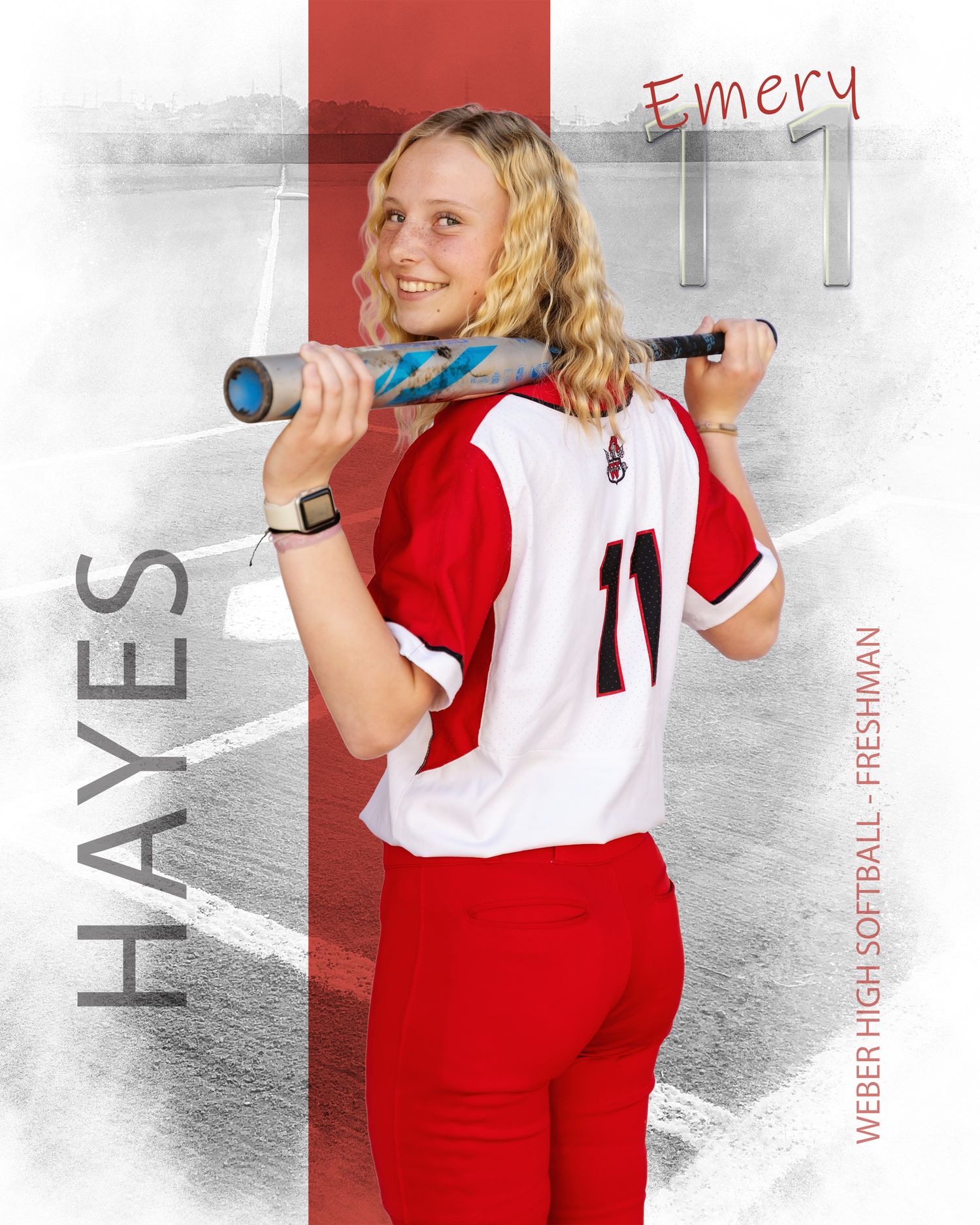 Emery Hayes, Weber High School freshman softball player number 11, poses with a bat over her shoulders in a red and white uniform.