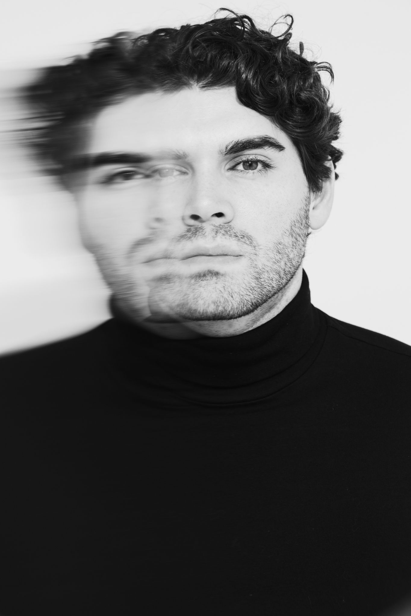 High contrast black and white portraits with motion blur effect.