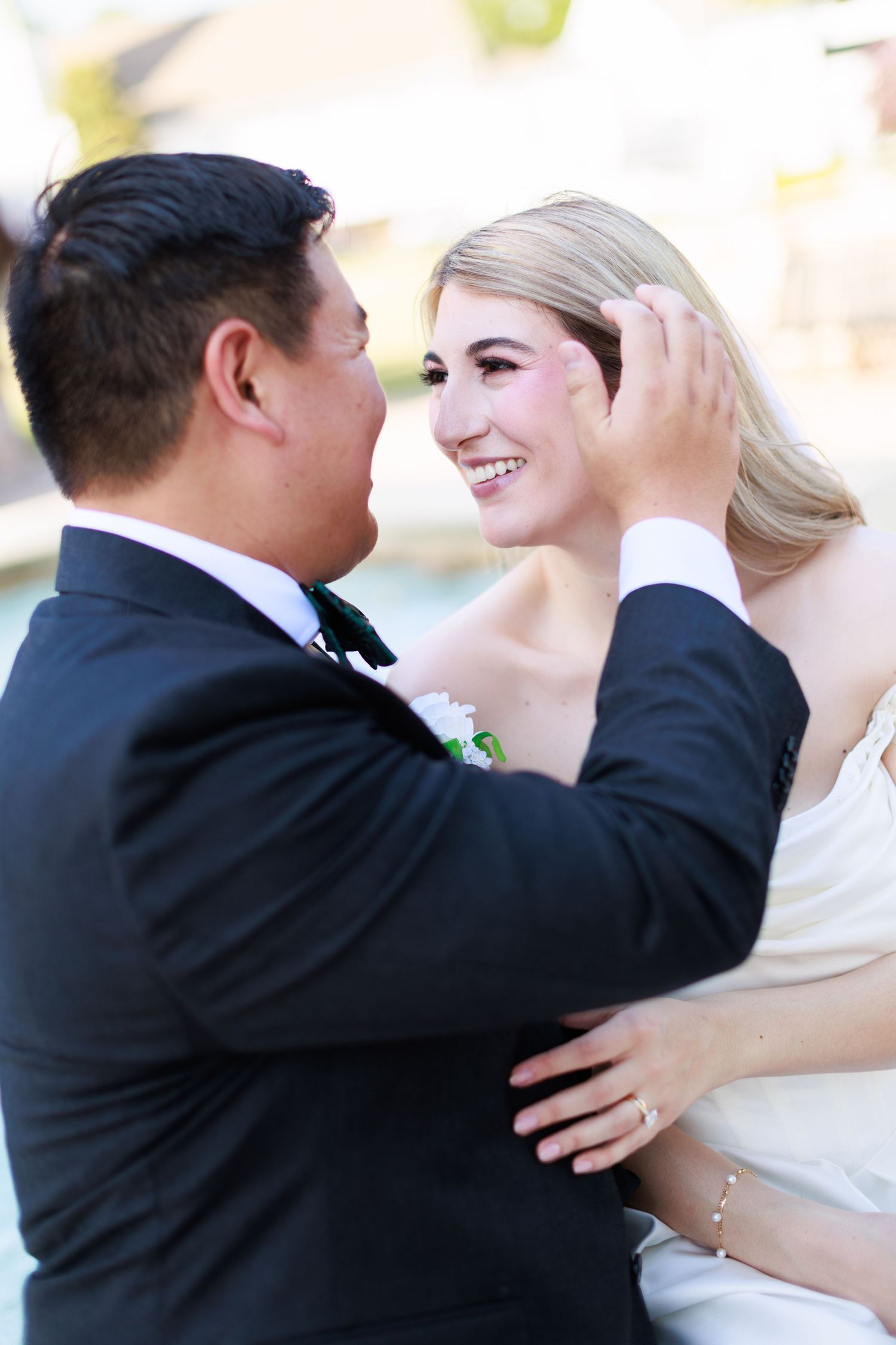 Elegant wedding couple shares intimate moments during outdoor portrait session.