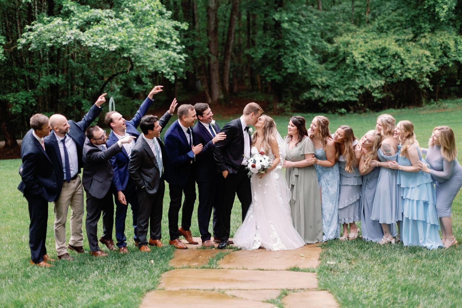 Outdoor wedding party photos with bridesmaids in blue dresses and groomsmen in navy suits.