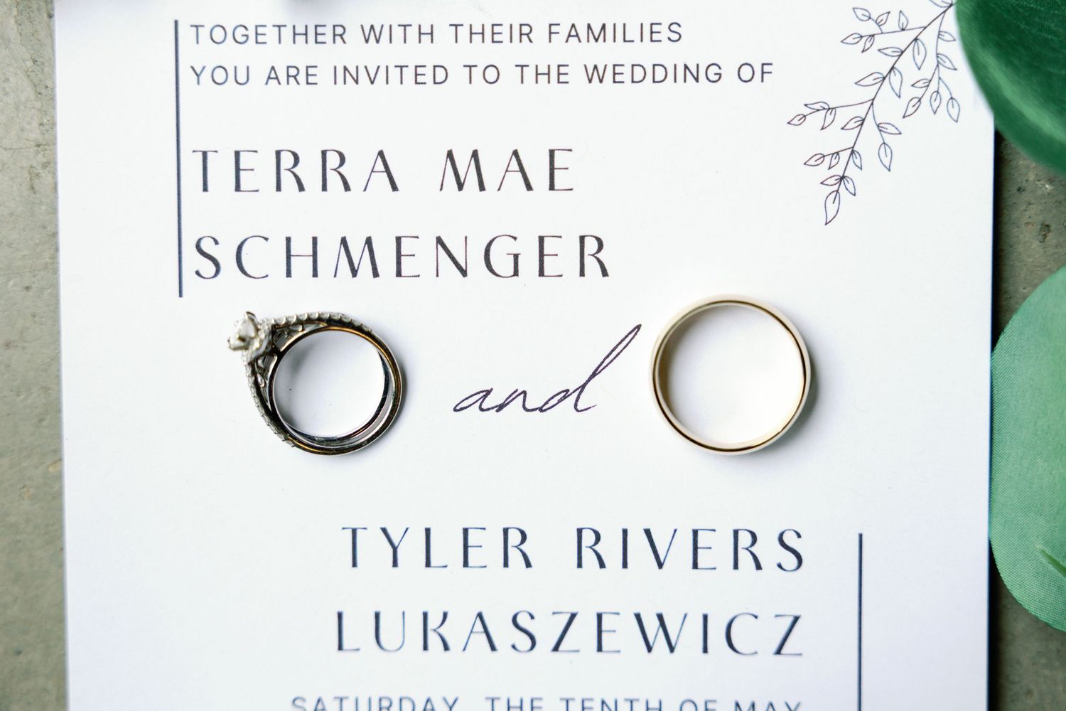Minimalist wedding invitation featuring elegant typography and ring details.