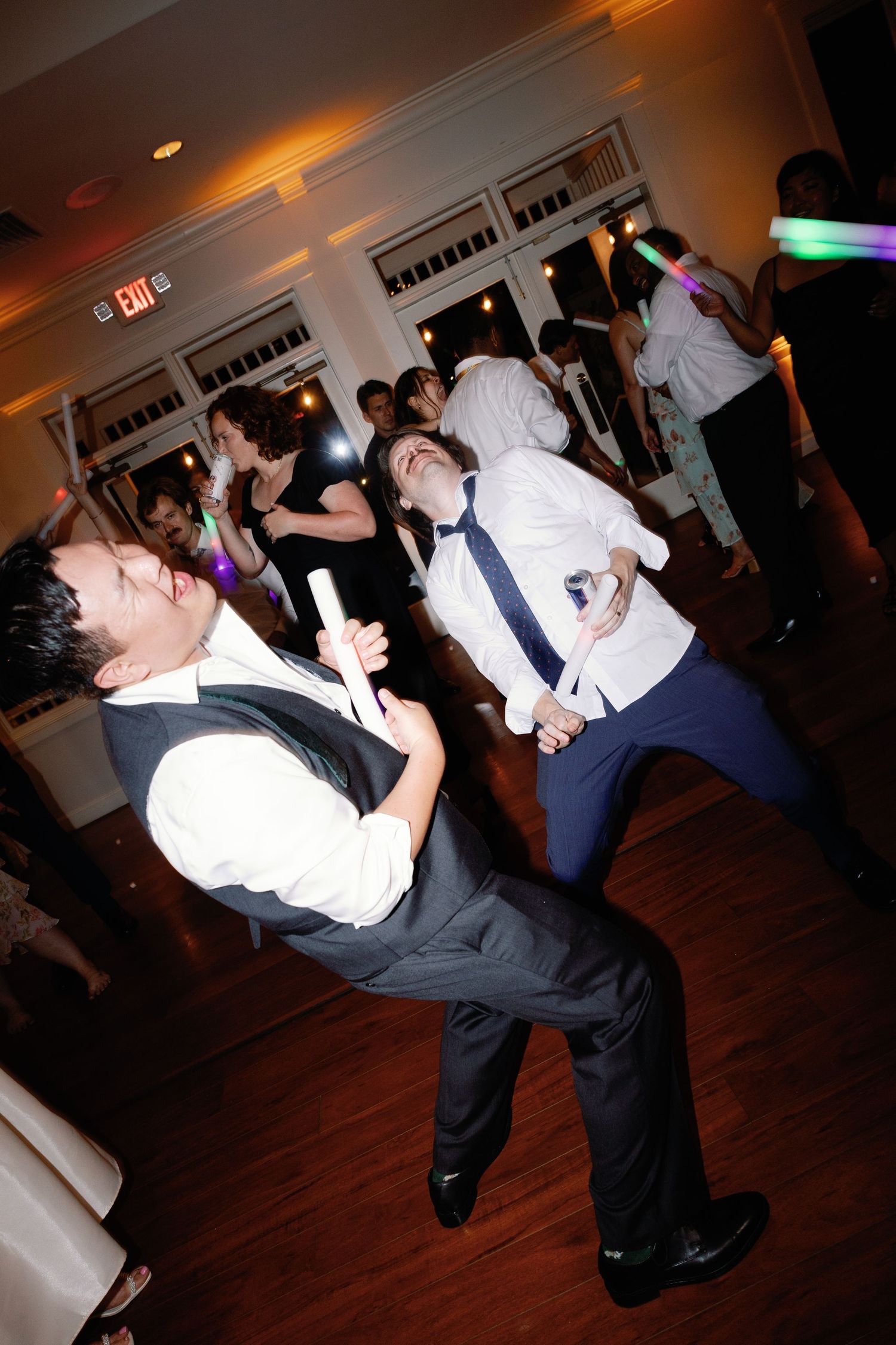 Dancing couple performs a dramatic dip move on the wedding reception dance floor.