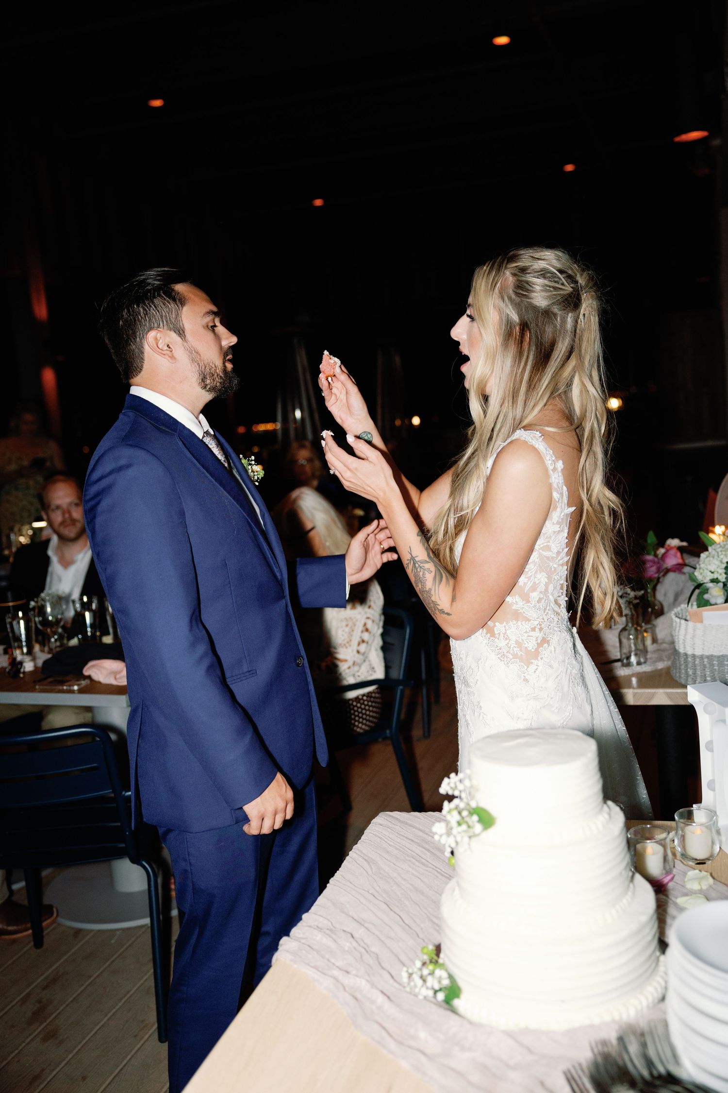 Newlyweds dancing together at their wedding reception with joyful expressions.