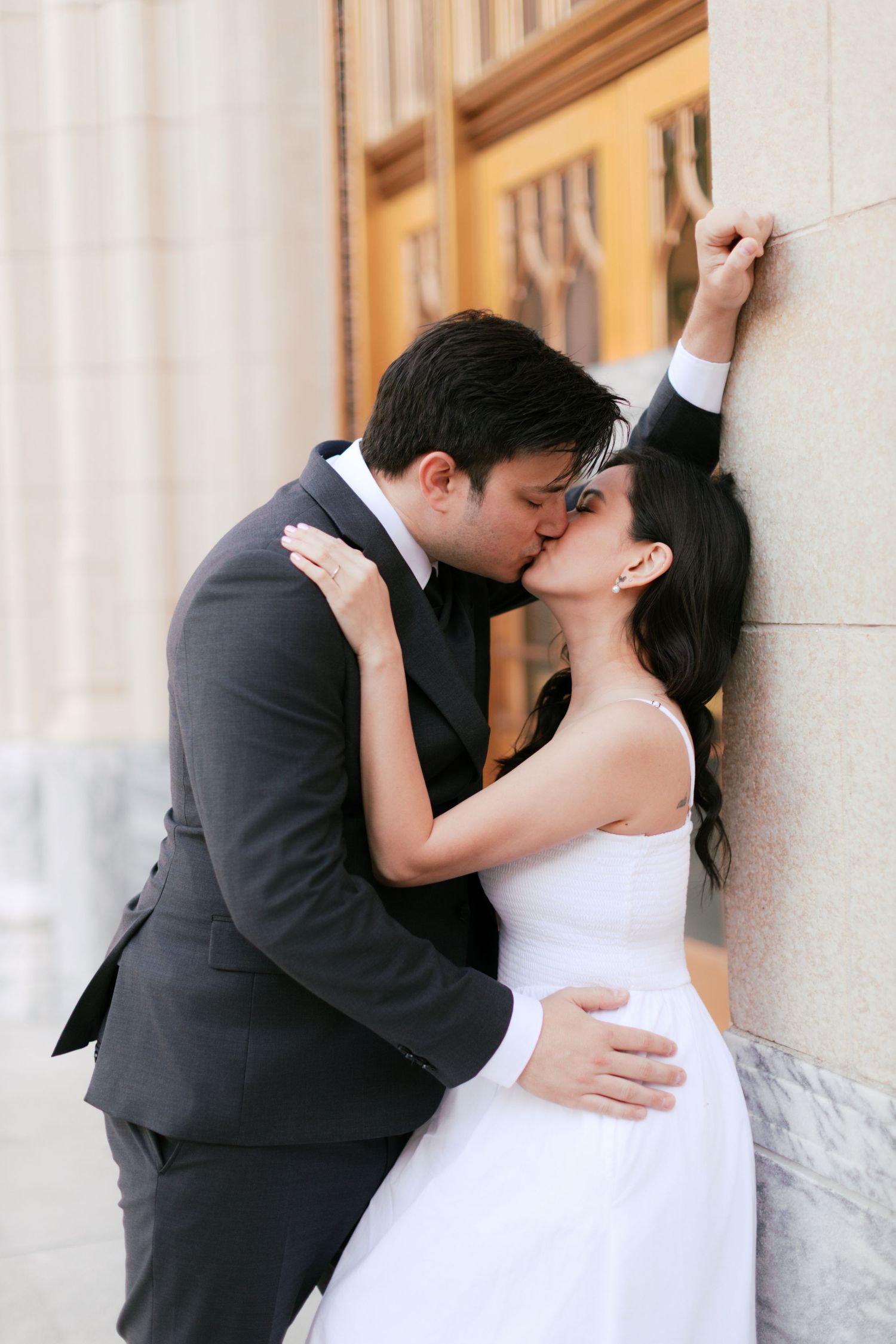 Romantic wedding portraits against classic stone columns and architecture.