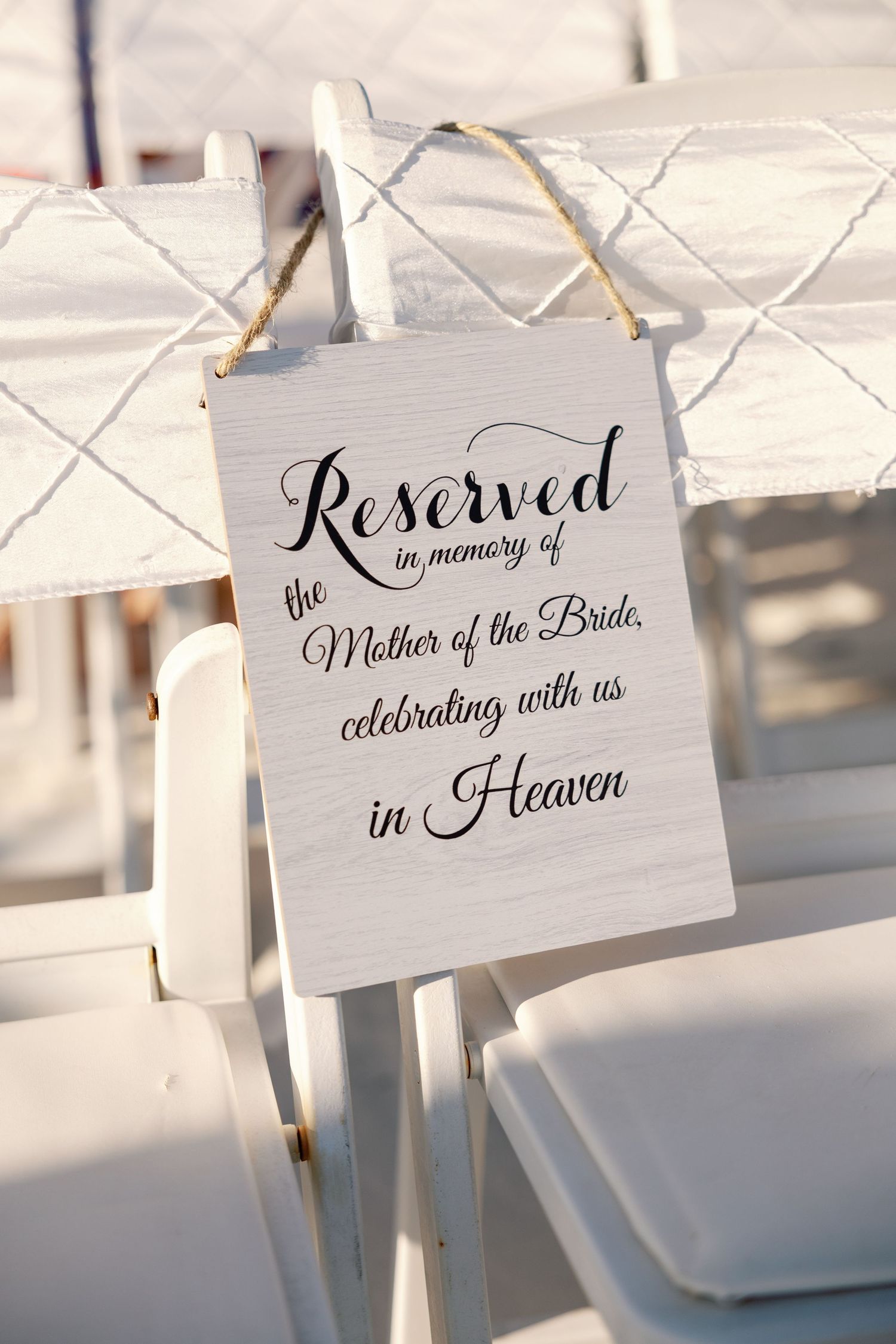 Reserved seating sign in elegant calligraphy for a memory table at a wedding ceremony.
