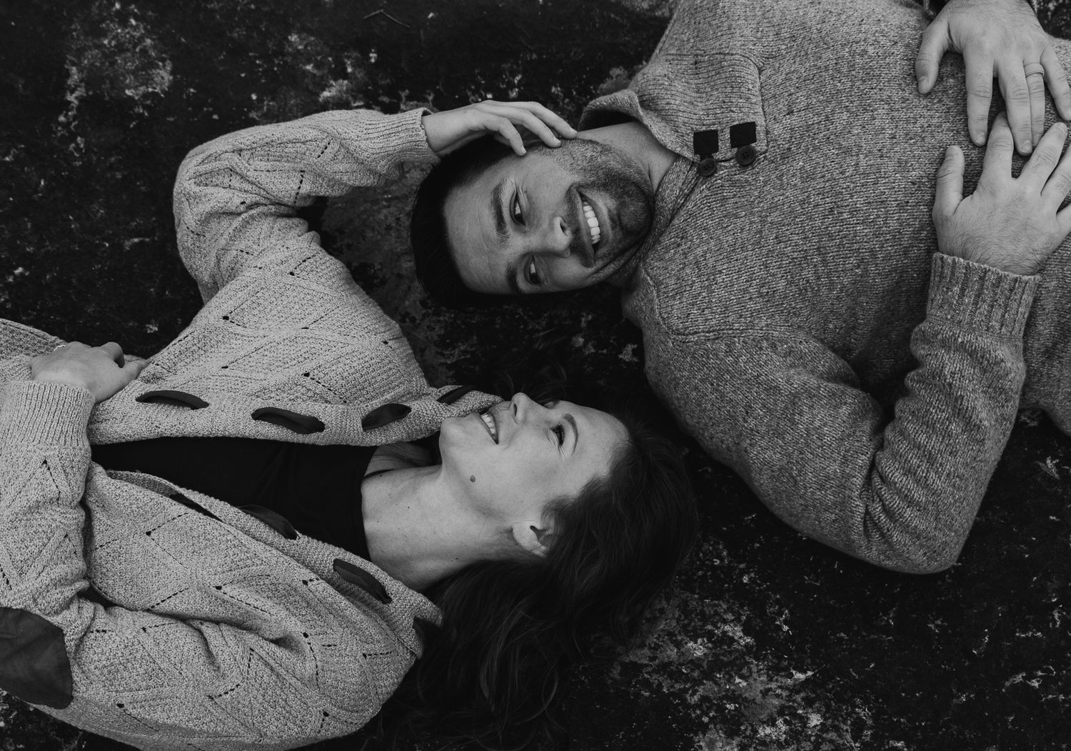 Black and white images of a couple lying together sharing intimate moments.