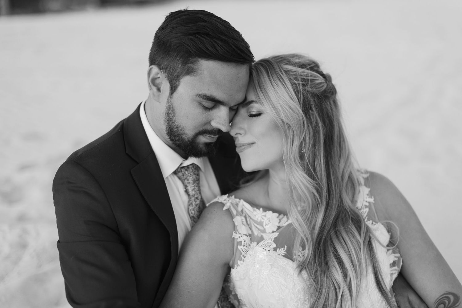 Black and white intimate portraits of couple in formal wedding attire.