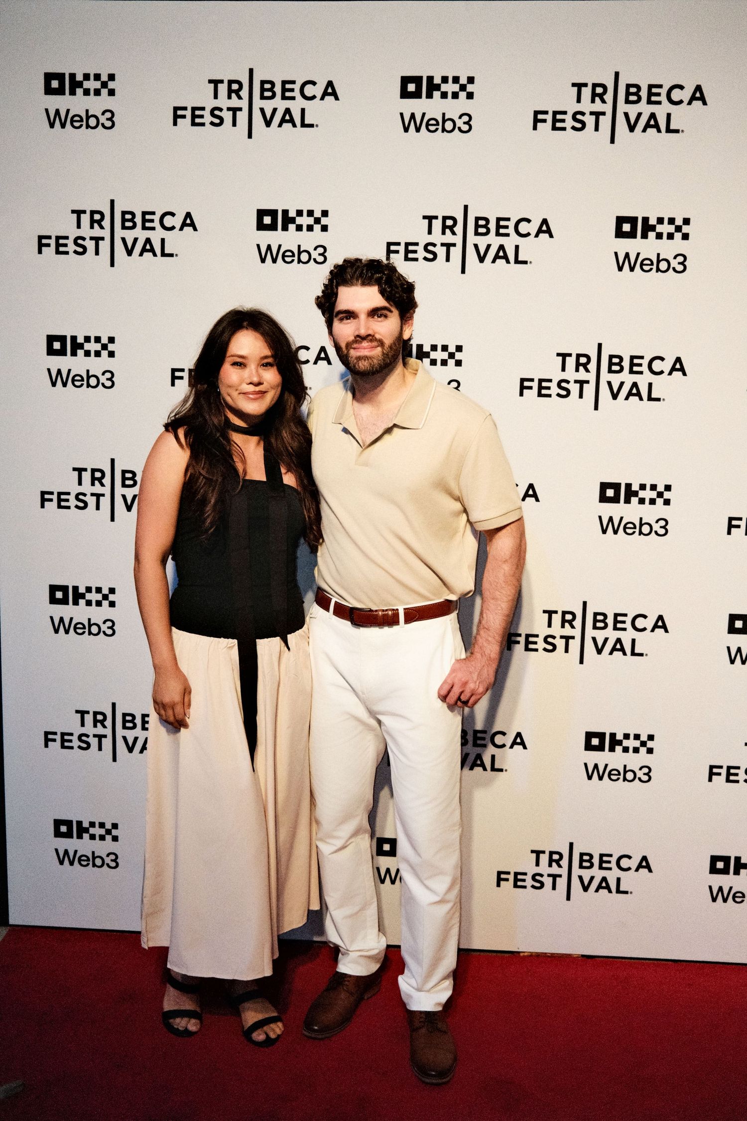 Event photography at Tribeca Festival with branded media wall backdrop.