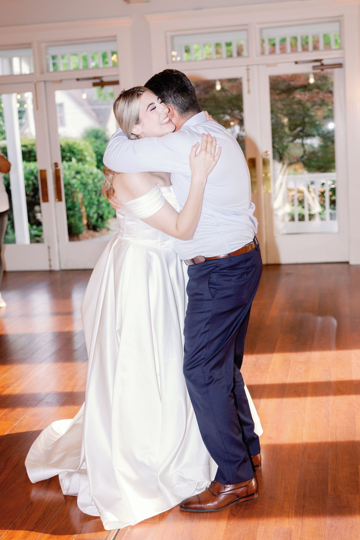 A sequence of romantic dance dips in a sun-lit ballroom with polished hardwood floors.