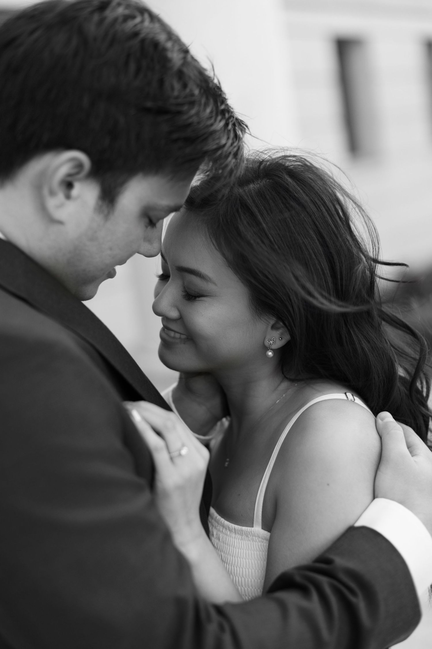 Intimate black and white portrait of a couple sharing a tender moment together.