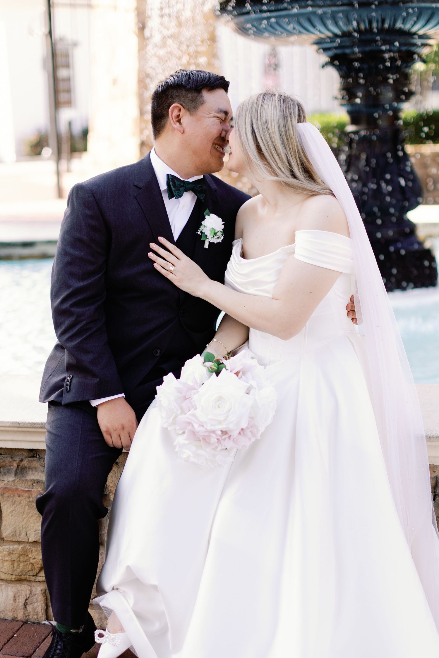 Romantic outdoor wedding portraits with elegant white dress details.