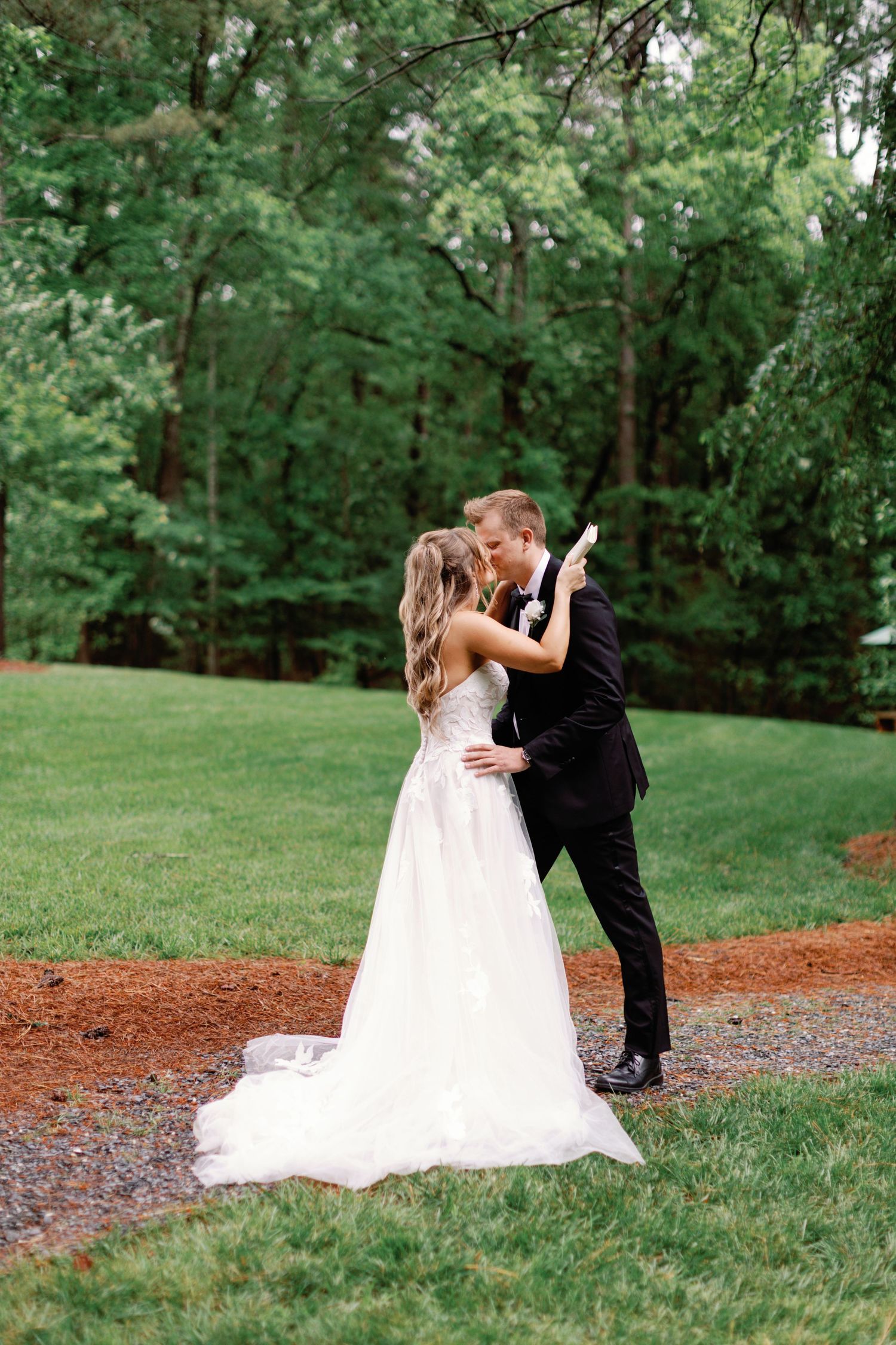 A romantic wedding moment captured in a serene garden setting.