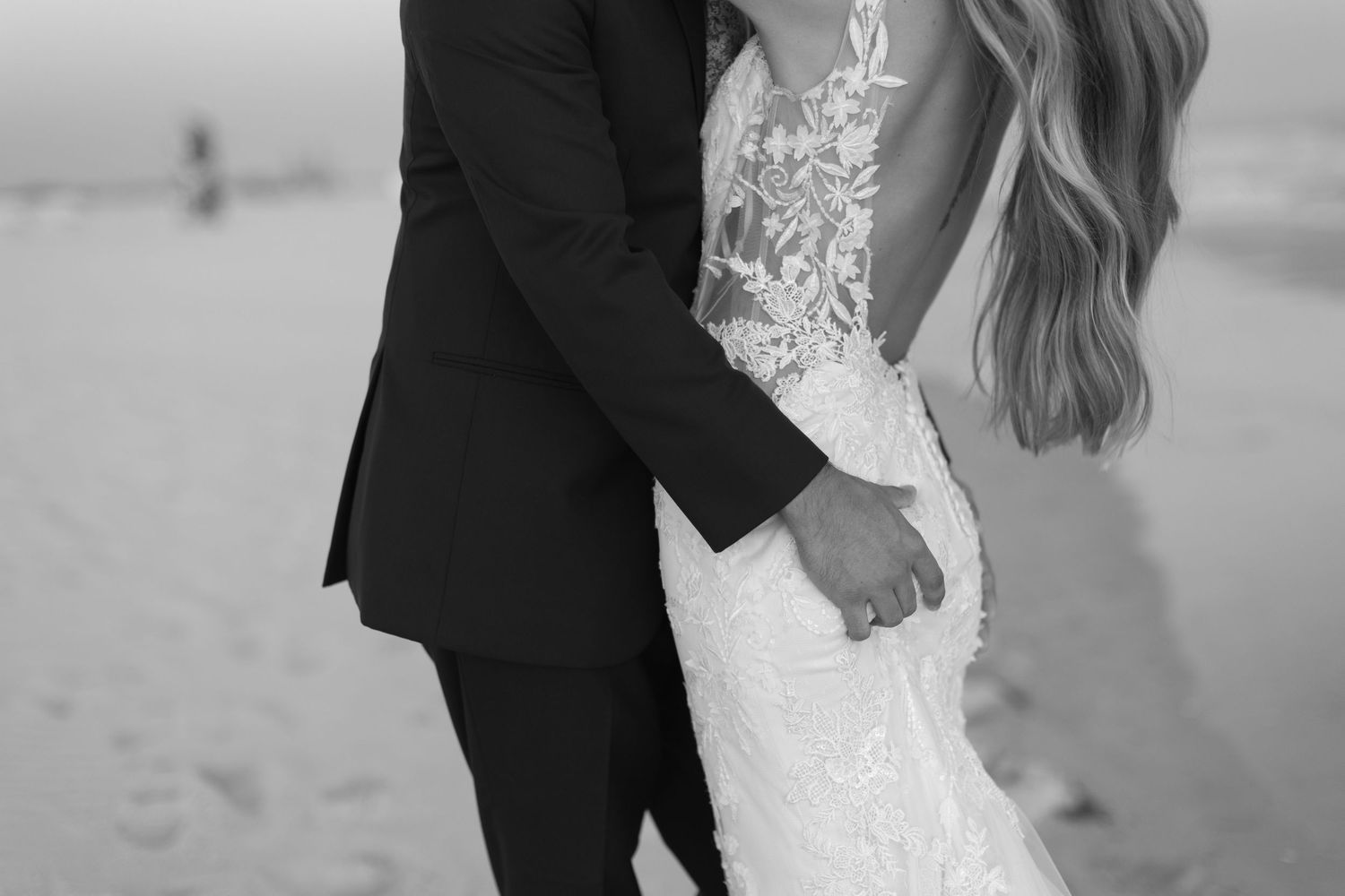 Elegant beach wedding portraits featuring lace dress details and tender moments.