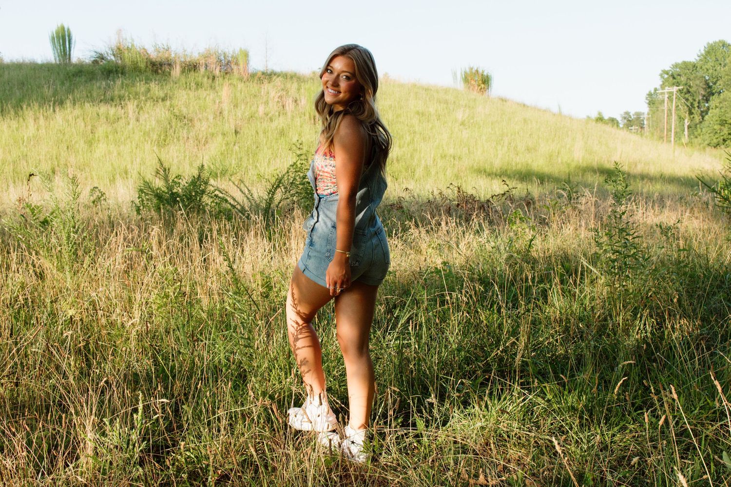 Candid outdoor photos in sunny meadow with tall grass.
