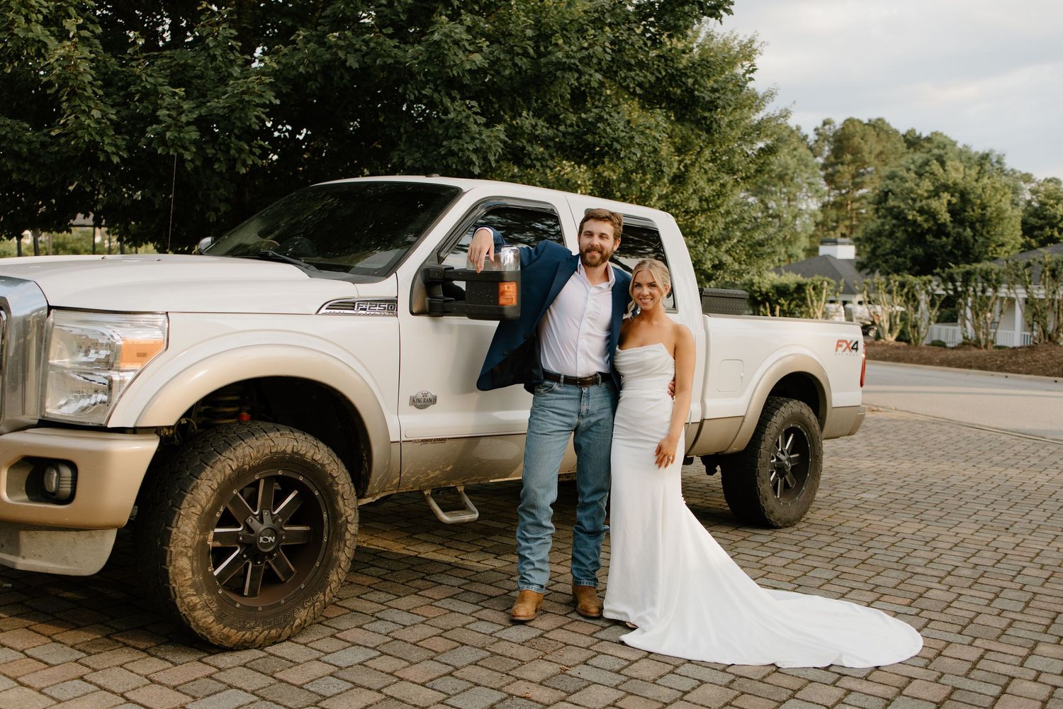 A wedding couple poses near a rustic pickup truck in a series of candid outdoor photographs.
