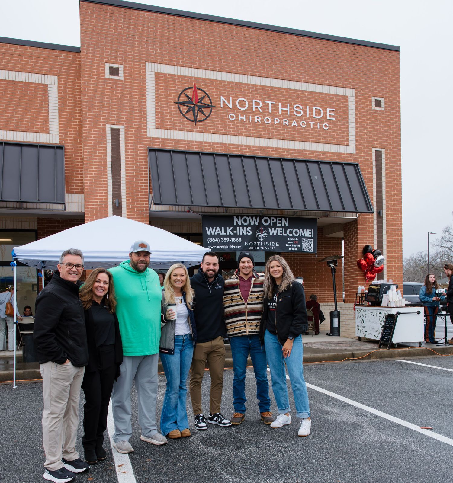 People lined up outside Northside Chiropractic building during grand opening celebration.